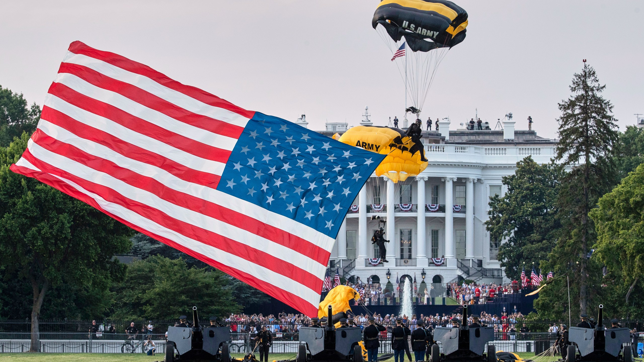 FILE - President Donald Trump and first lady Melania Trump watch as the U.S. Army Golden Knights Parachute Team descend during a "Salute to America" event on the South Lawn of the White House, July 4, 2020, in Washington. (AP Photo/Alex Brandon, File)