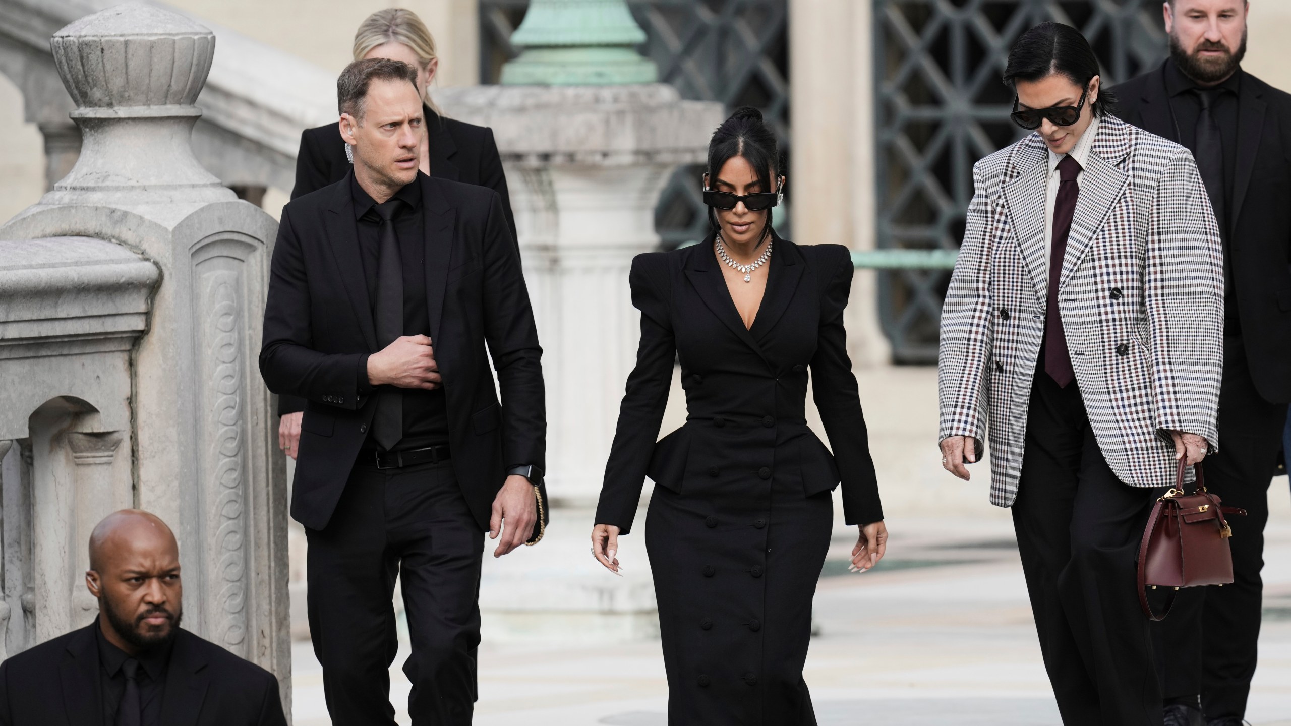 Kim Kardashian, center, accompanied by her mother Kris Jenner, second right, leaves the justice palace after testifying, regarding a robbery of millions of dollars in jewels from her Paris hotel room in 2016, in Paris, Tuesday, May 13, 2025. (AP Photo/Aurelien Morissard)