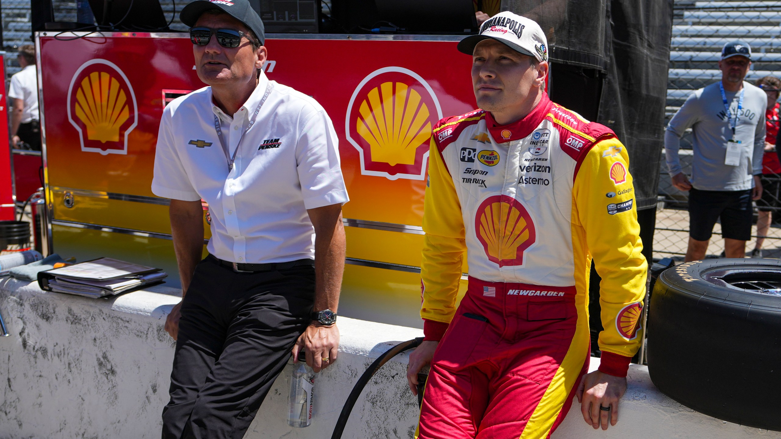 President of Team Penske Tim Cindric, left and driver Josef Newgarden wait for the start of during practice for the Indianapolis 500 auto race at Indianapolis Motor Speedway in Indianapolis, Sunday, May 18, 2025. (AP Photo/Michael Conroy)