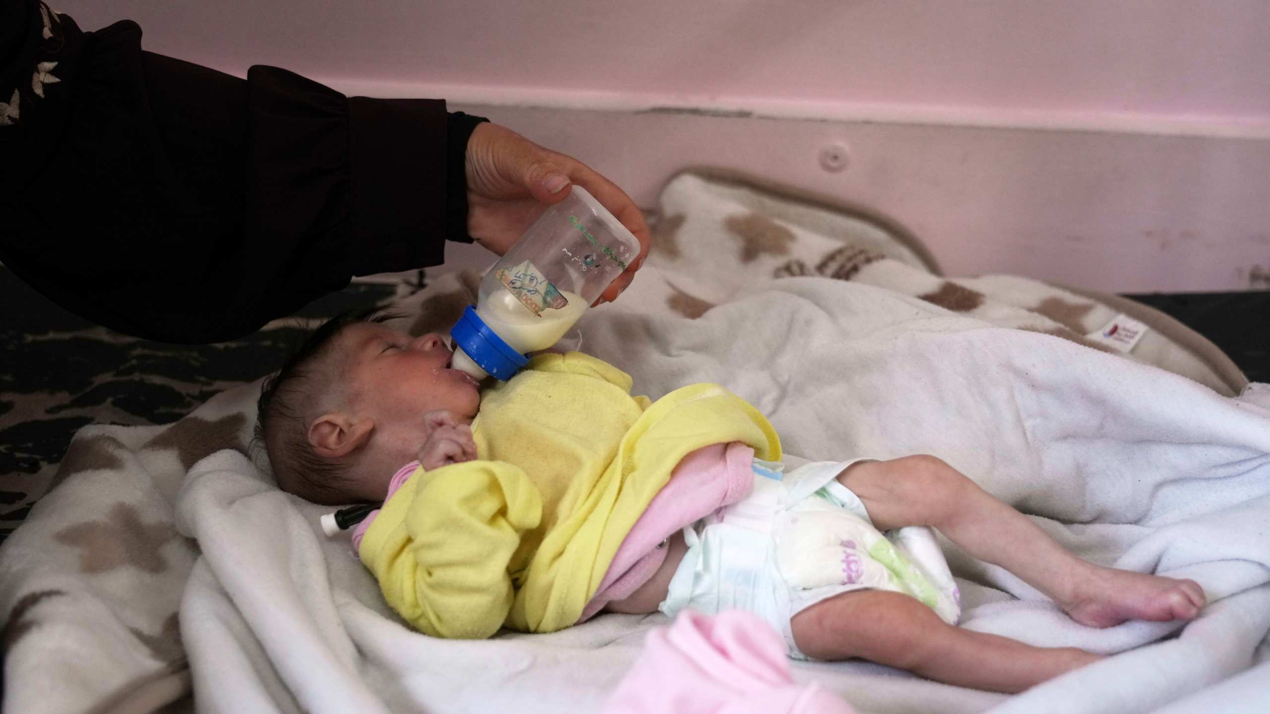 Najia Al-Najjar feeds her 5-month-old baby, Yousef, who suffers from malnutrition, at a clinic in Nasser hospital, Khan Younis, Gaza, Wednesday, May 21, 2025. (AP Photo/Abdel Kareem Hana)