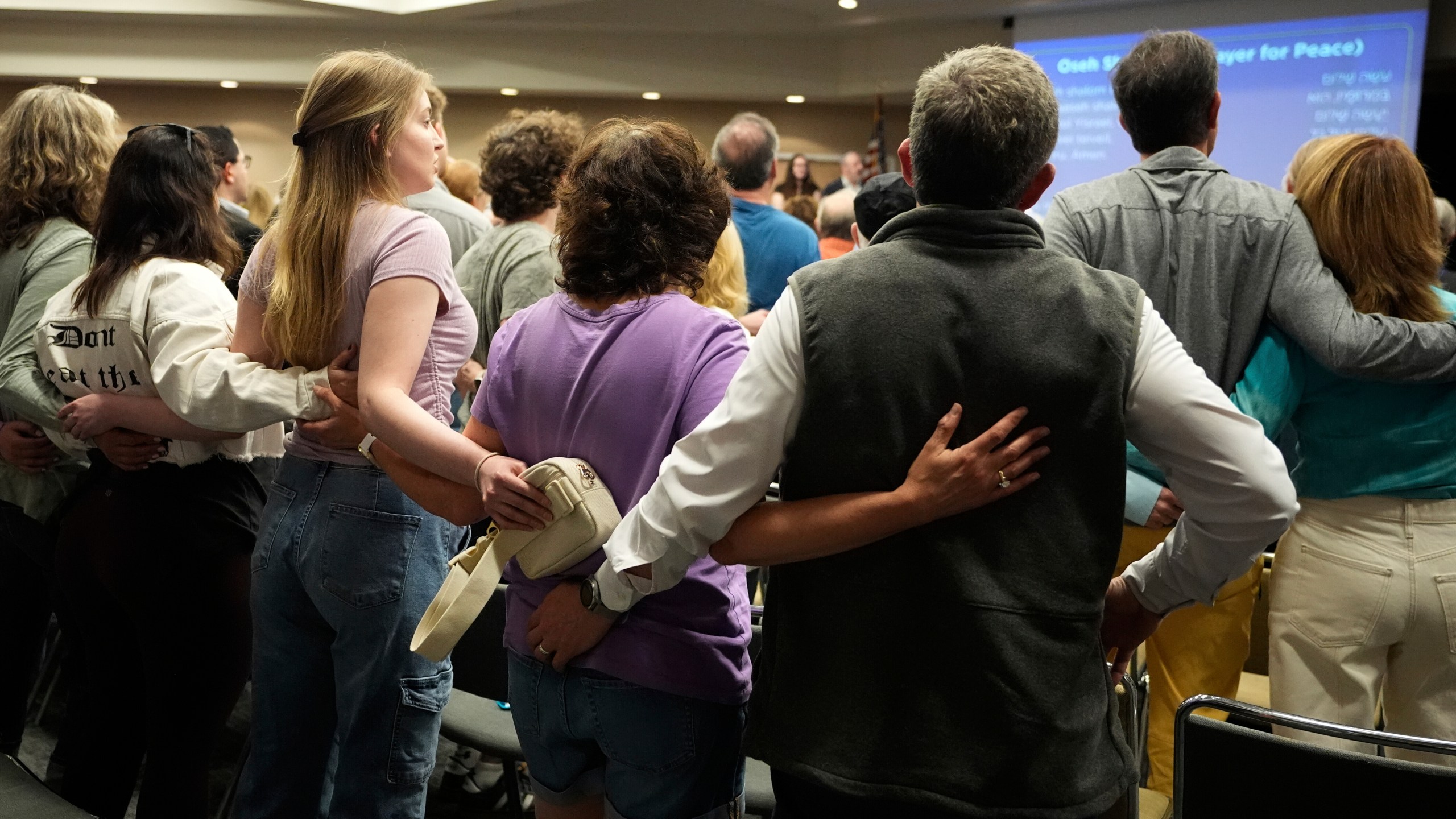People attend a vigil at the Jewish Community Center of Greater Kansas City for Sarah Milgrim and Yaron Lischinsky, Israeli Embassy staff members who were shot and killed while leaving an event at a Jewish museum in Washington, Thursday, May 22, 2025, in Overland Park, Kan. (AP Photo/Charlie Riedel)