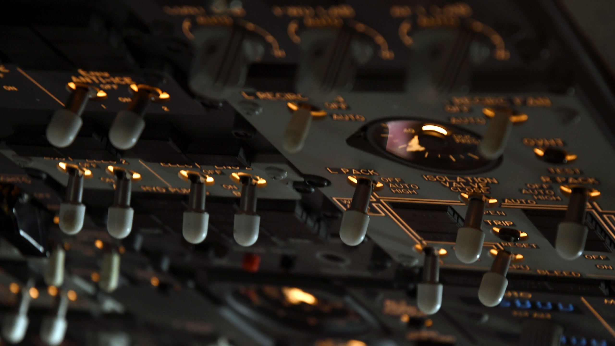Switches in the cockpit of a United Airlines flight simulator are lit up at the company's training campus in Denver, Friday, May 16, 2025. (AP Photo/Thomas Peipert)