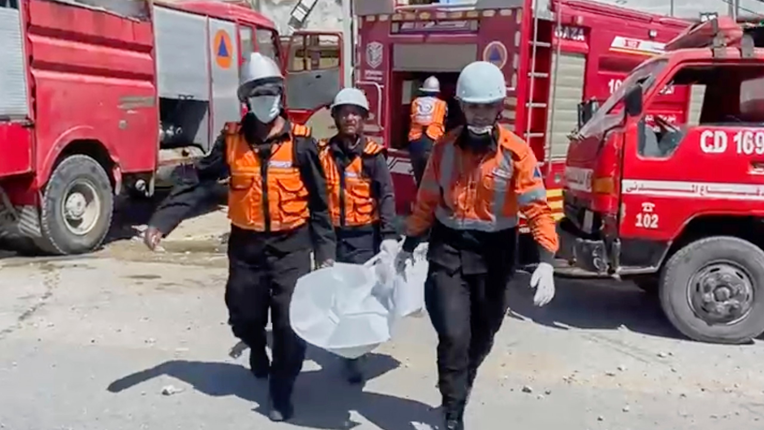 In this frame grab from a video released by Gaza Civil Defense, workers collect human remains after an Israeli strike on a home in Khan Younis killed nine of a doctor's ten children while she was at work, according to Ahmad al-Farra, head of the pediatric department at Nasser Hospital, in Khan Younis, Gaza Strip, Saturday, May 24, 2025. (Gaza Civil Defense via AP)