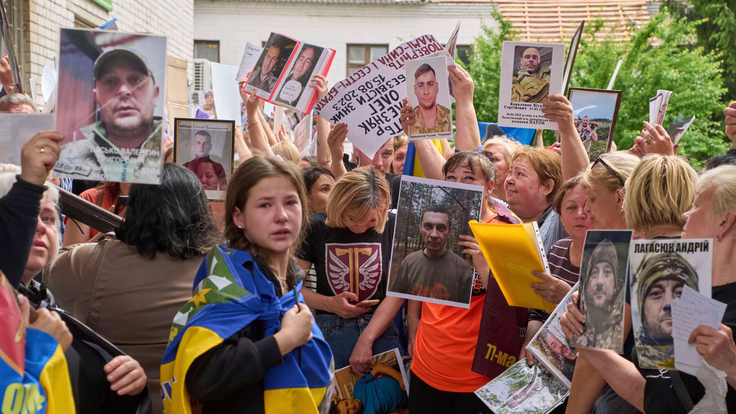 Relatives show photos of missing soldiers