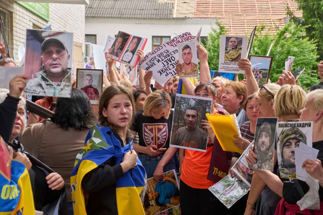 Relatives show photos of missing soldiers