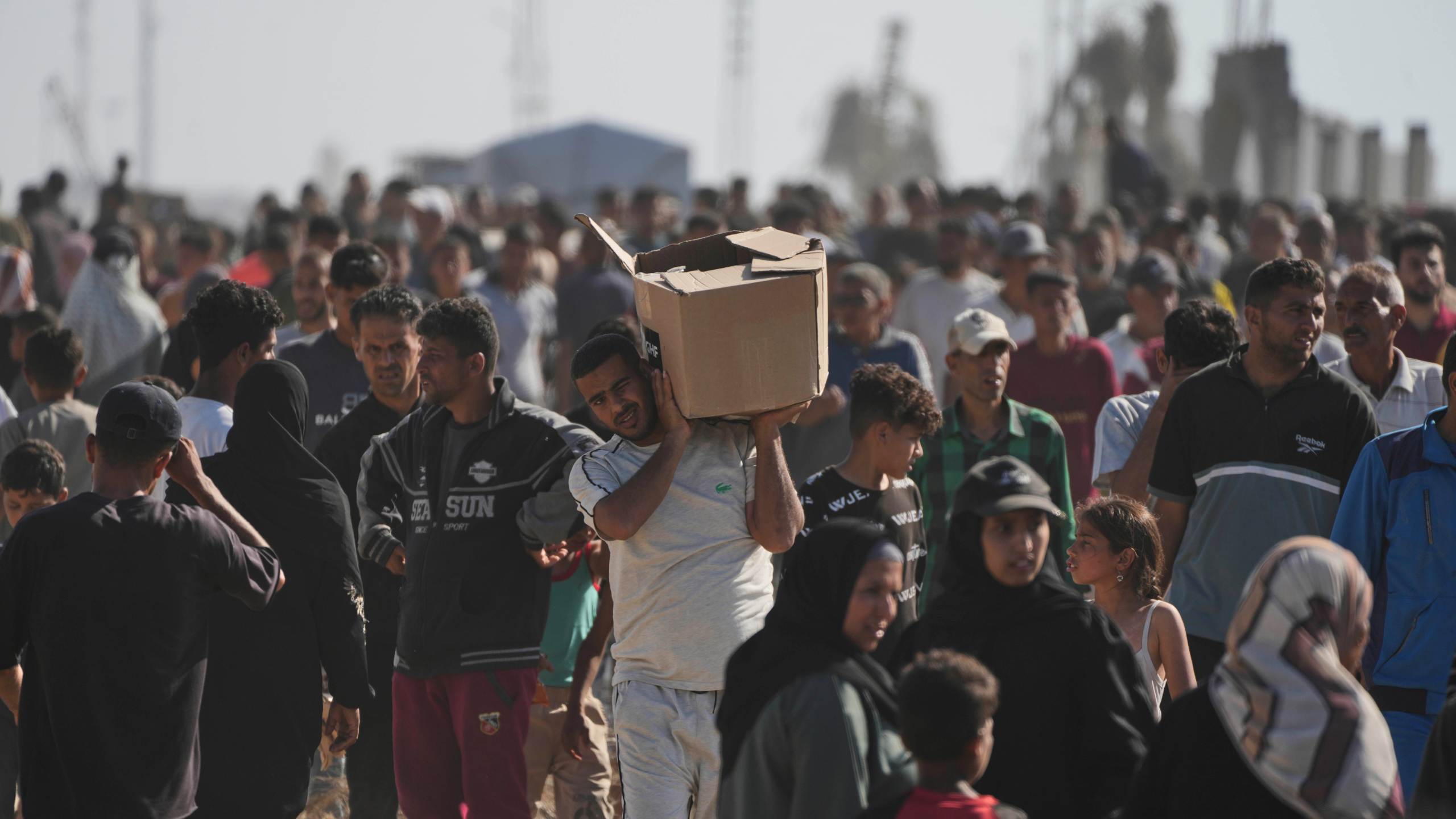 Palestinians carry boxes containing food and humanitarian aid packages delivered by the Gaza Humanitarian Foundation, a U.S.-backed organization approved by Israel, in Rafah, southern Gaza Strip, on Tuesday, May 27, 2025. (AP Photo/Abdel Kareem Hana)