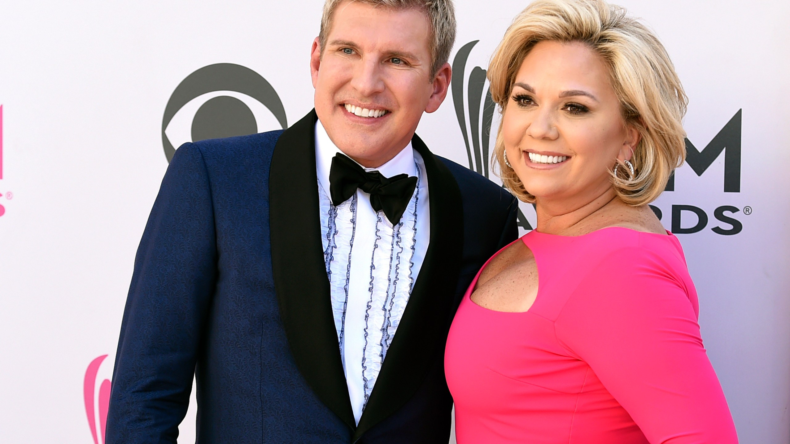 FILE - Julie Chrisley, right, and her husband Todd Chrisley pose for photos at the 52nd annual Academy of Country Music Awards April 2, 2017, in Las Vegas. (Jordan Strauss/Invision/AP, File)
