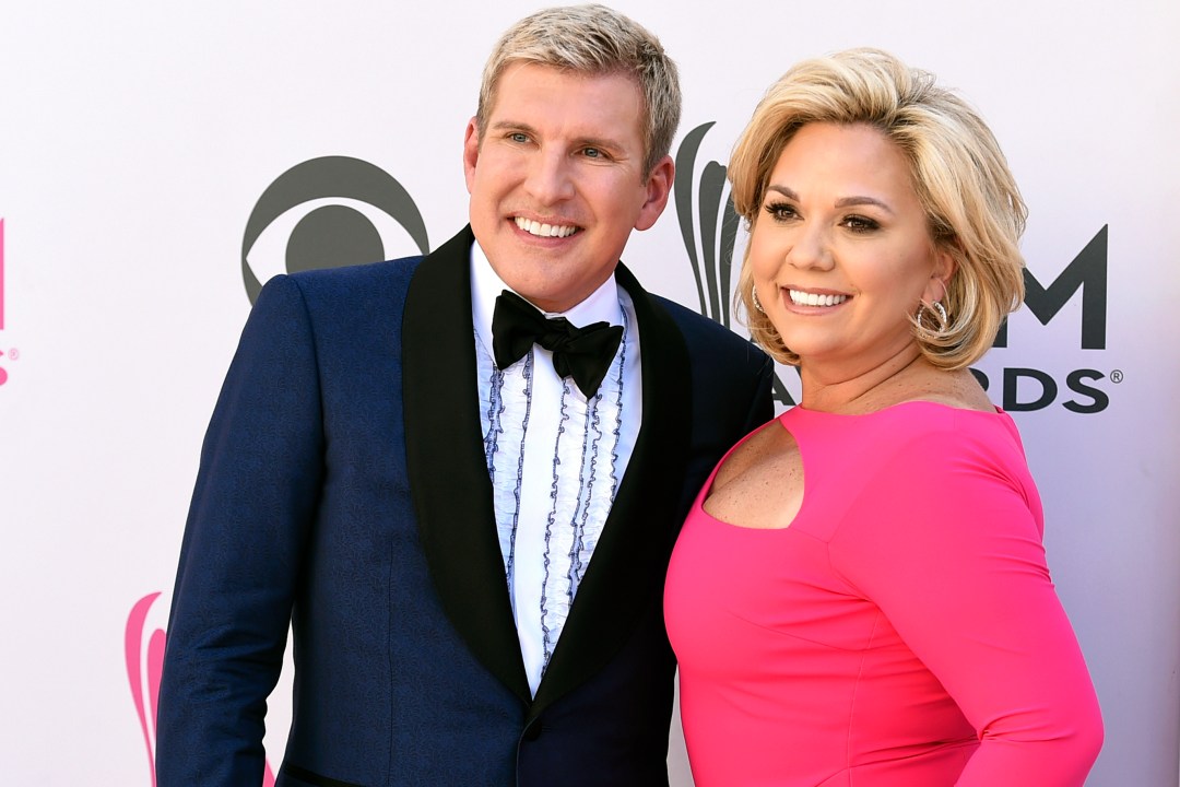 FILE - Julie Chrisley, right, and her husband Todd Chrisley pose for photos at the 52nd annual Academy of Country Music Awards April 2, 2017, in Las Vegas. (Jordan Strauss/Invision/AP, File)