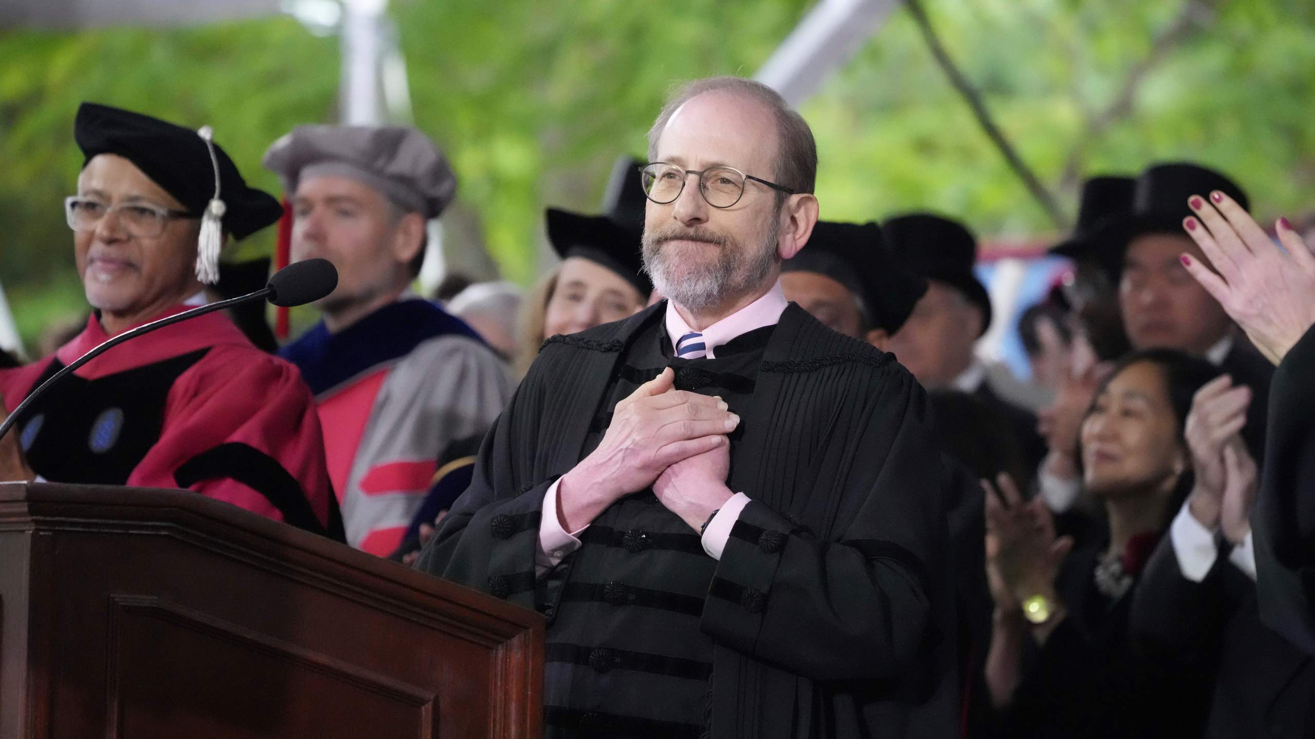 Harvard President Alan Garber acknowledges an extended round of applause during Harvard University's commencement ceremonies, Thursday, May 29, 2025 in Cambridge, Mass. (AP Photo/Charles Krupa)