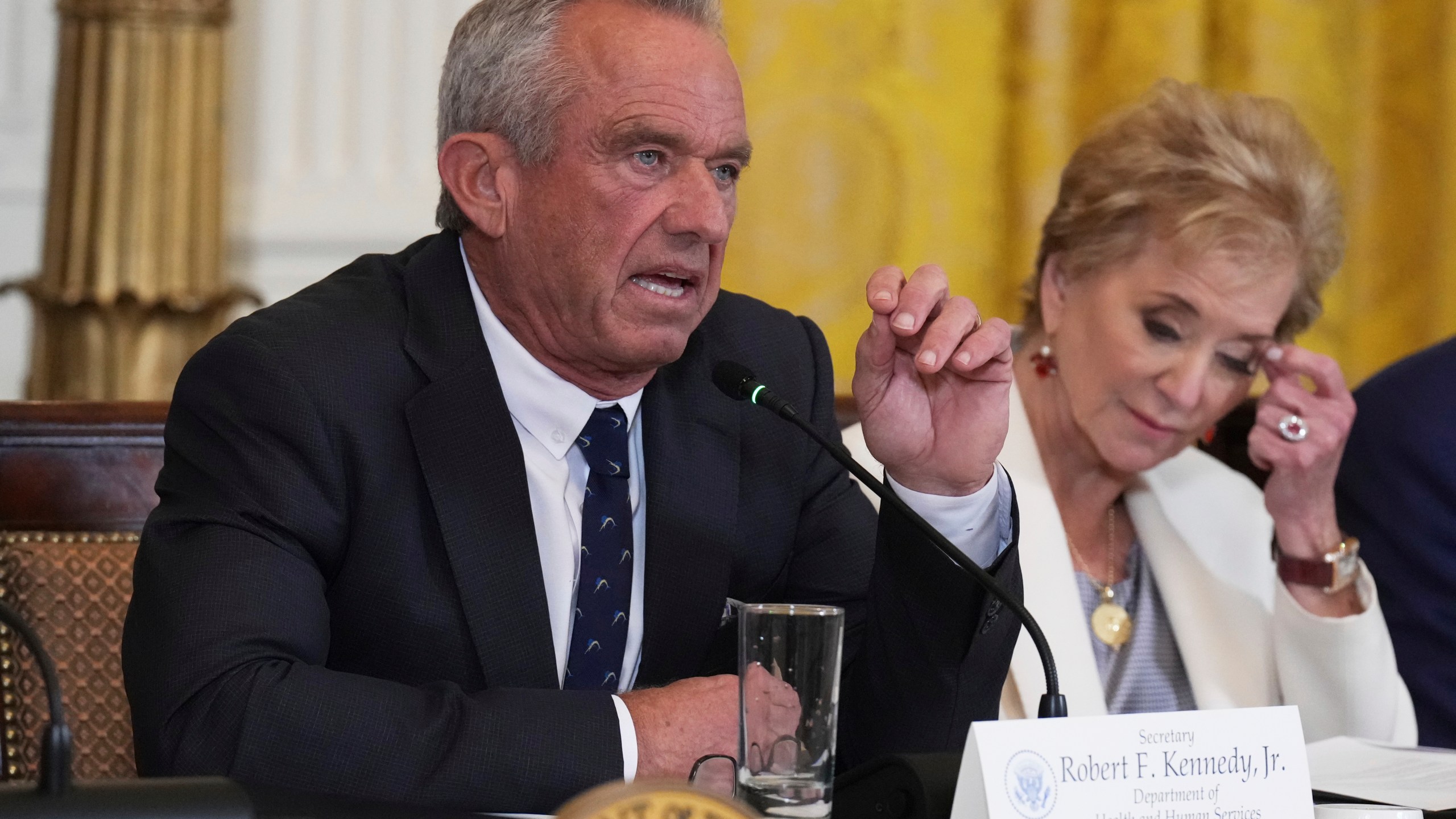 Health and Human Services Secretary Robert F. Kennedy Jr. speaks as Education Secretary Linda McMahon listens during a Make America Healthy Again (MAHA) Commission Event in the East Room of the White House, Thursday, May 22, 2025, in Washington. (AP Photo/Jacquelyn Martin)