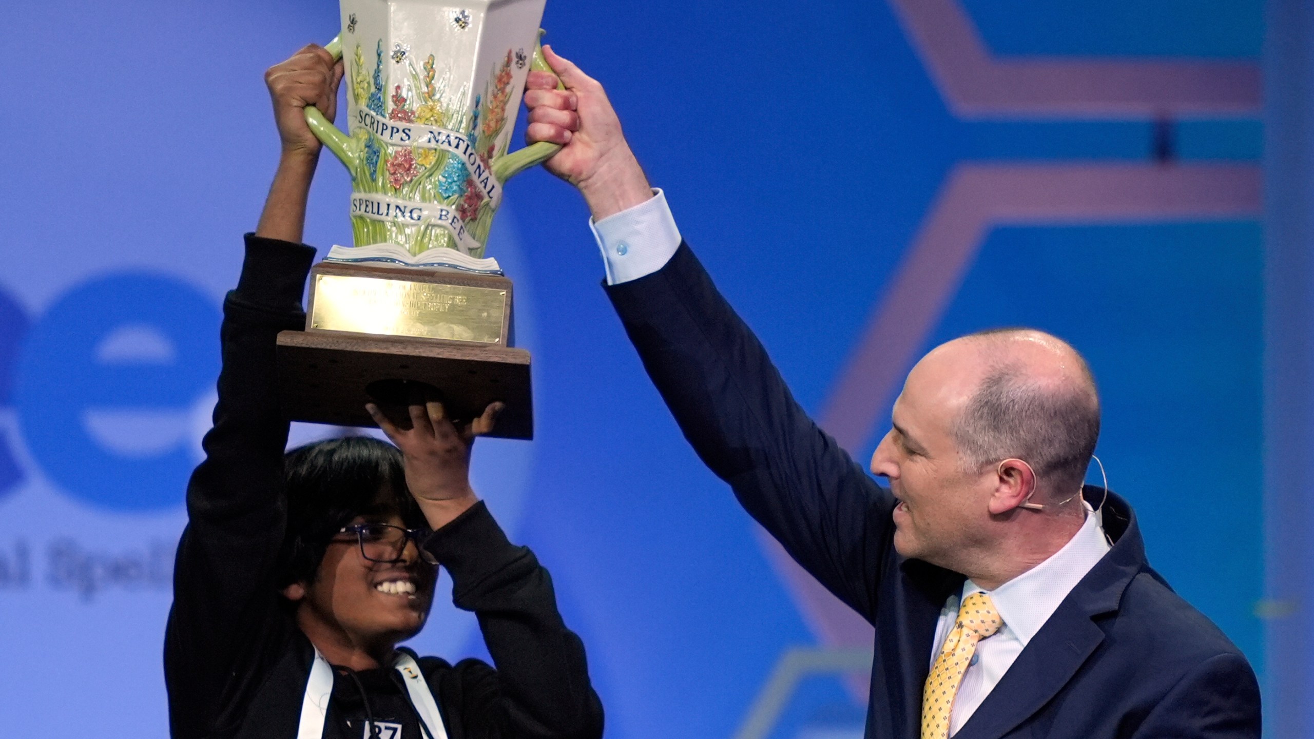 E.W. Scripps Company president and CEO Adam Symson presents the trophy to Faizan Zaki, 13, of Dallas, the winner of the 2025 Scripps National Spelling Bee, Thursday, May 29, 2025, in Oxon Hill, Md. (AP Photo/Julia Demaree Nikhinson)