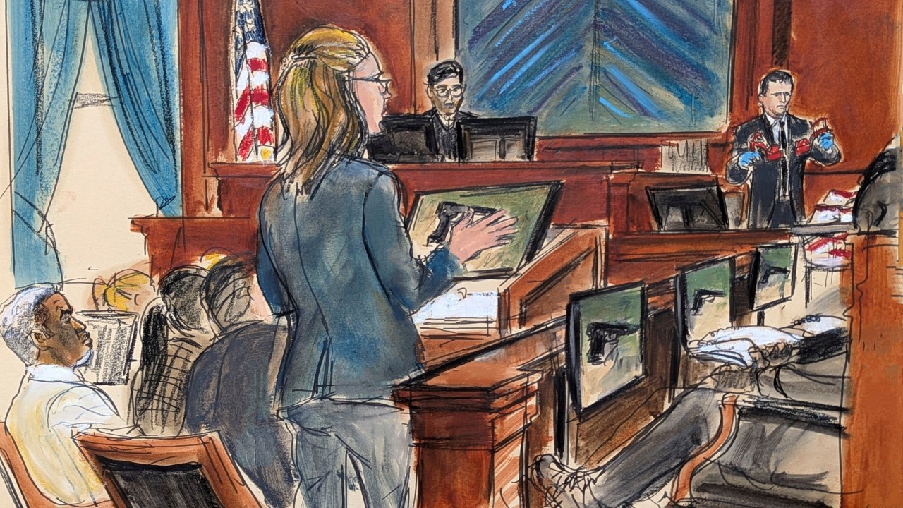 Assistant US Attorney Madison Smyser, center, asks Special Agent Gerard Gannon, far right, to stand and show the jury the high heeled platform red shoes found along with fire arms during a search of Combs' Star Island residence during Combs' sex trafficking and racketeering trial in Manhattan federal court, Wednesday, May 21, 2025, in New York. (Elizabeth Williams via AP)