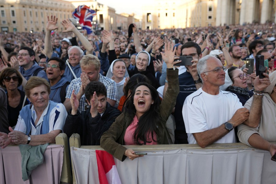 A crowd of onlookers cheer in Vatican City