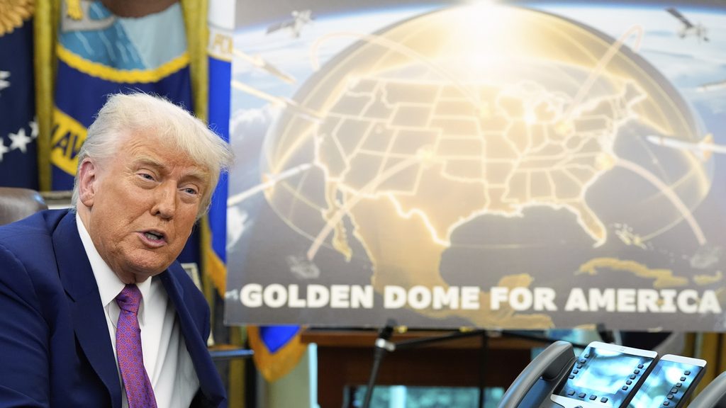 President Trump next to poster showing proposed Golden Dome for America