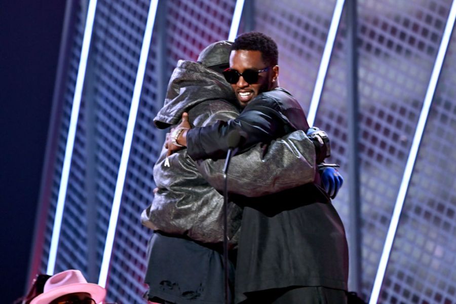 Sean "Diddy" Combs hugs Kanye West onstage