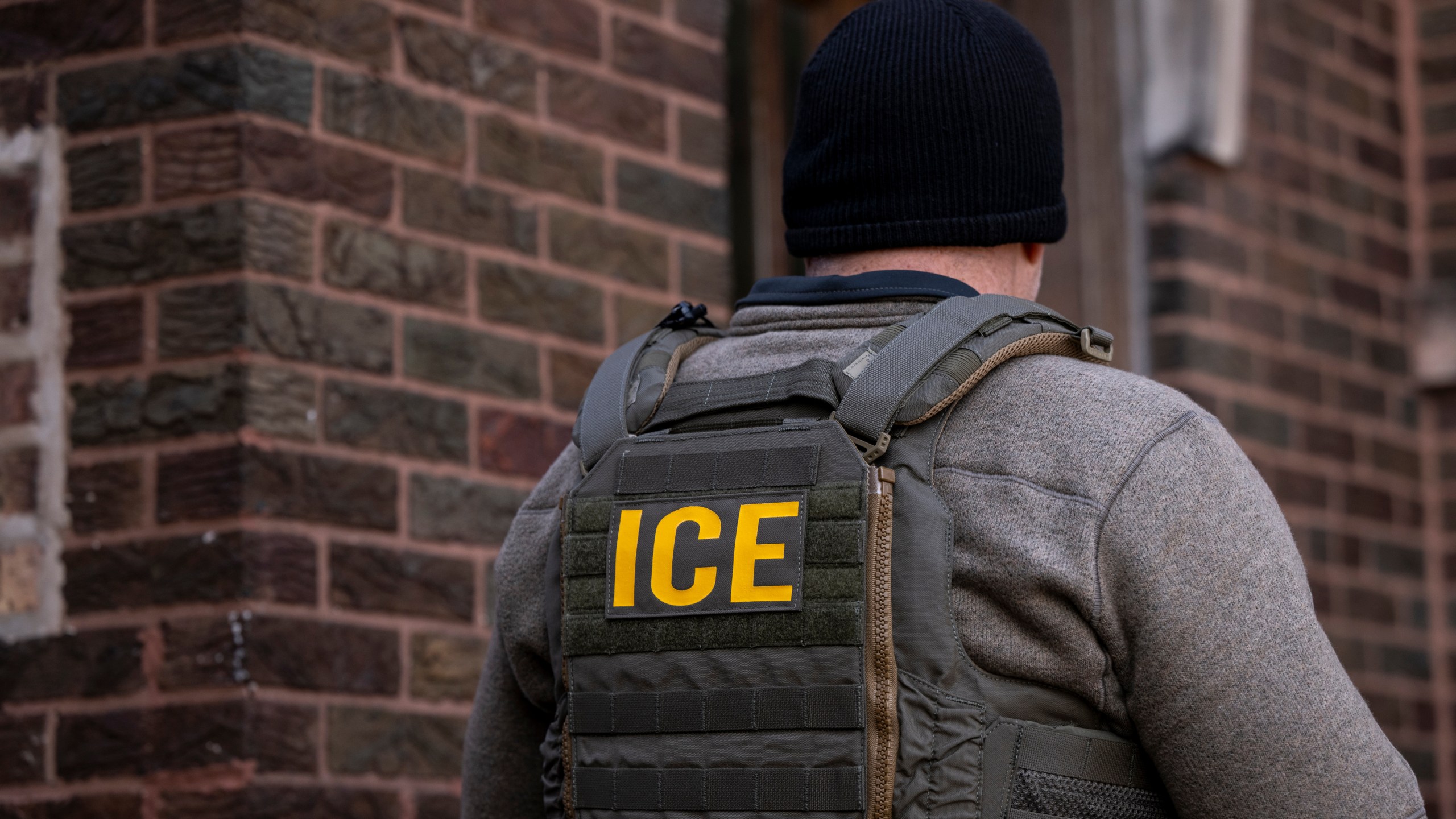 ICE officer seen from behind