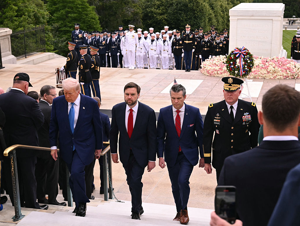 Trump, Vance and Hegseth walk up the steps from the tomb of the unknown soldier.
