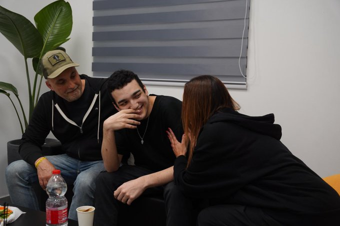 Edan Alexander smiles with family members