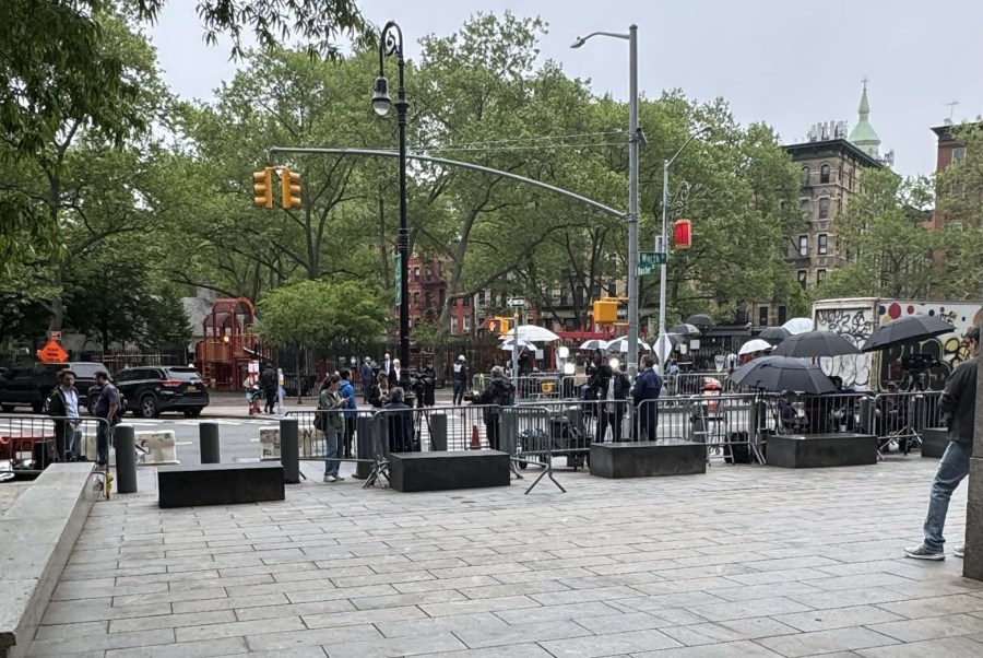 Media set  up equipment under tents outside a courthouse.