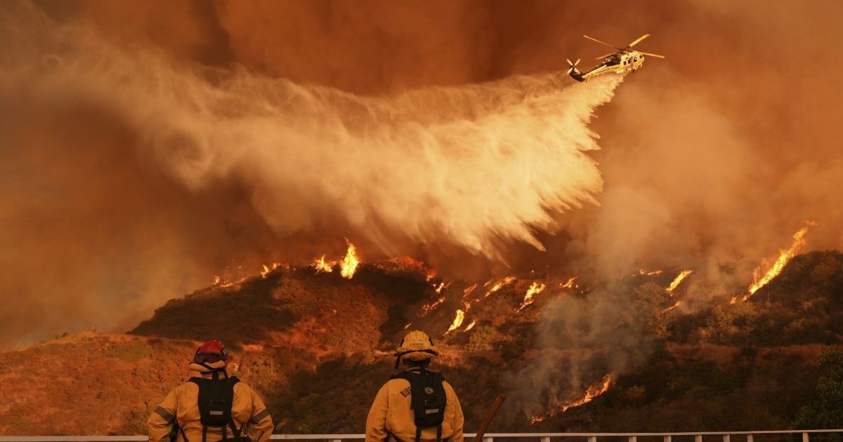 Water drops from an airplane on the Palisades fire