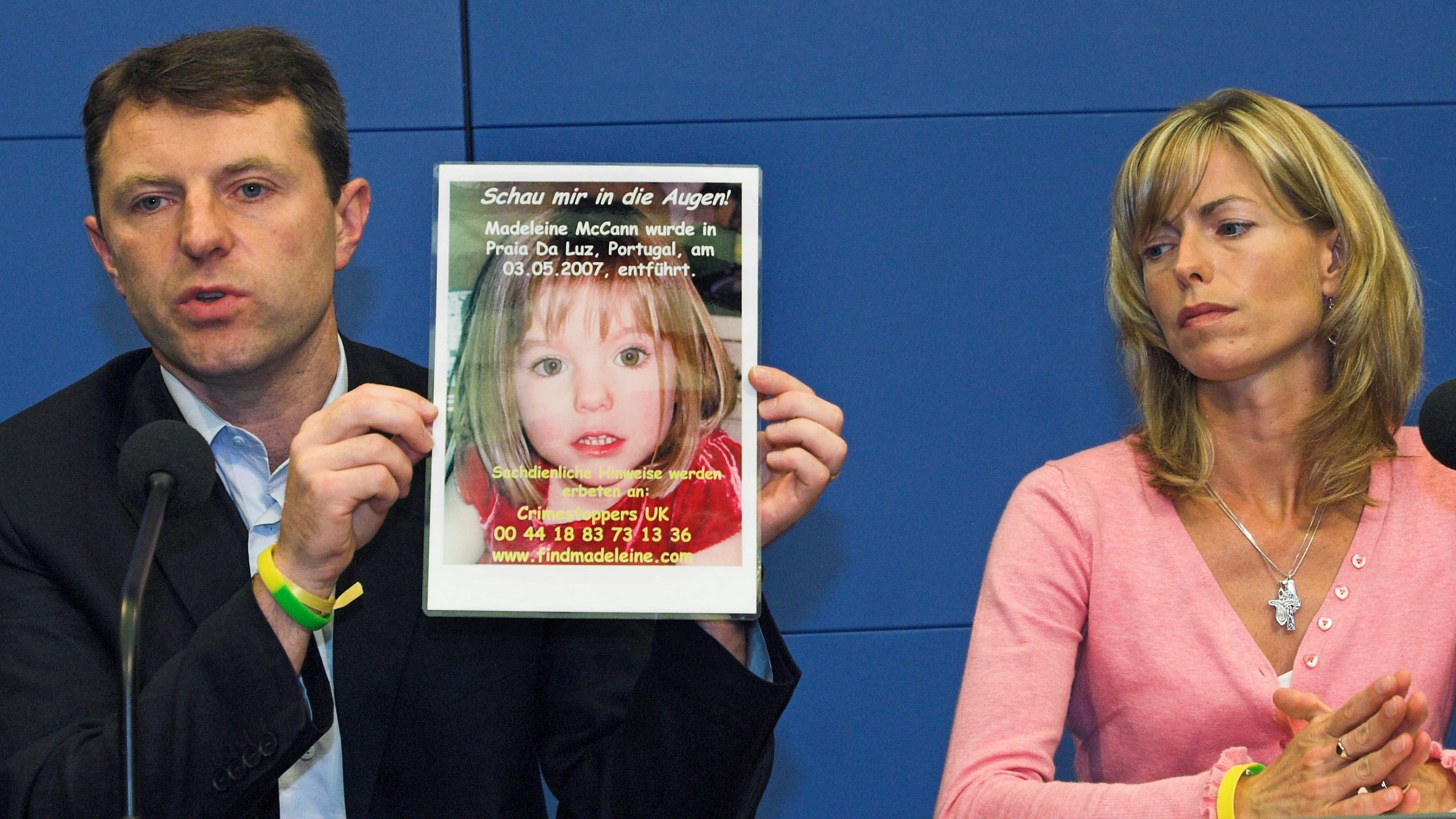 FILE - Gerry, left, and Kate McCann, parents of four-year old Madeleine McCann, present a picture of their daughter during a press conference in Berlin, Wednesday, June 6, 2007. (AP Photo/Sven Kaestner, File)