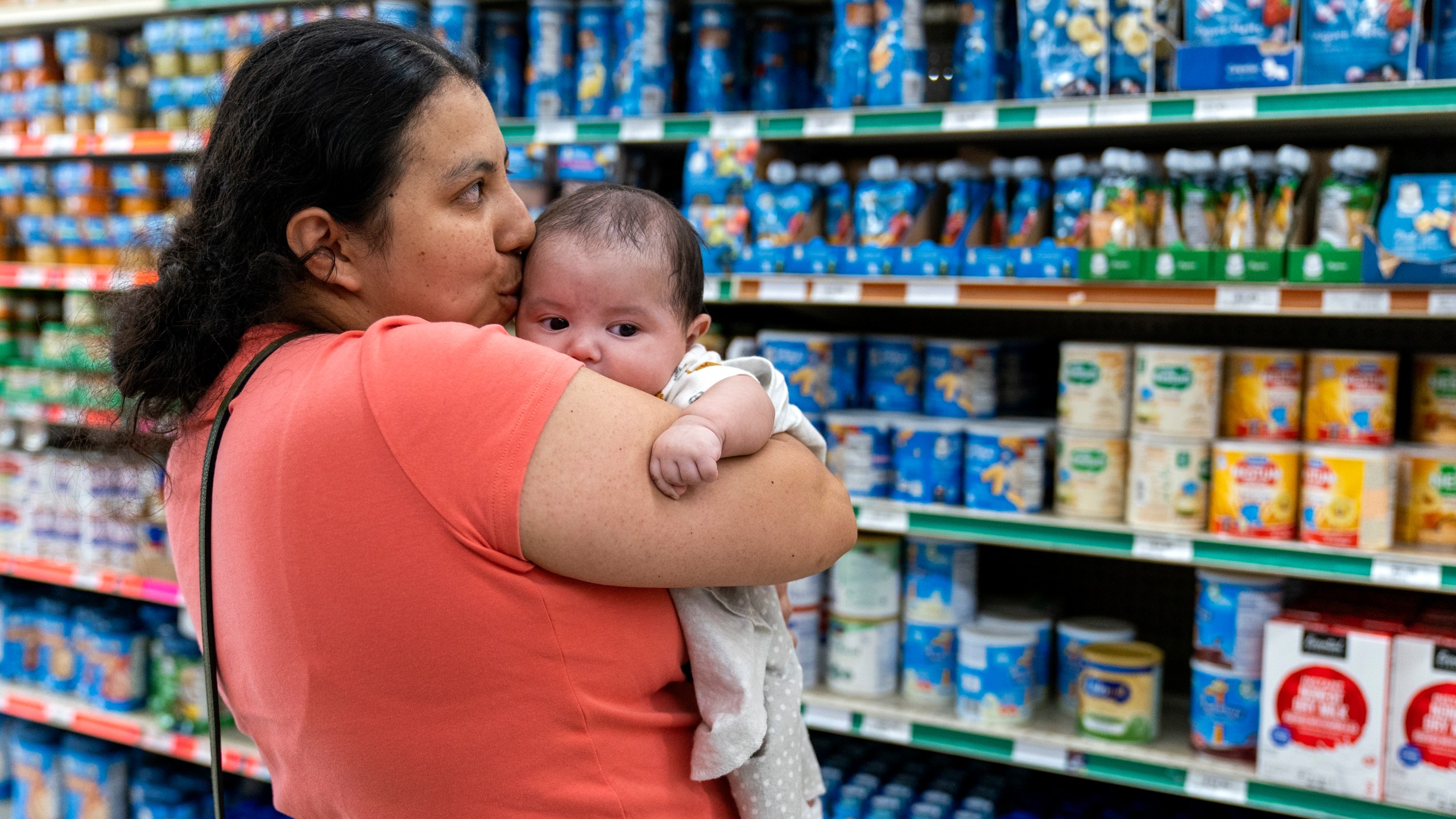 FILE - Yury Navas, 29, of Laurel, Md., kisses her two-month-old baby Jose Ismael Gálvez, at Superbest International Market in Laurel, Md., May 23, 2022, while looking for formula. (AP Photo/Jacquelyn Martin, file)