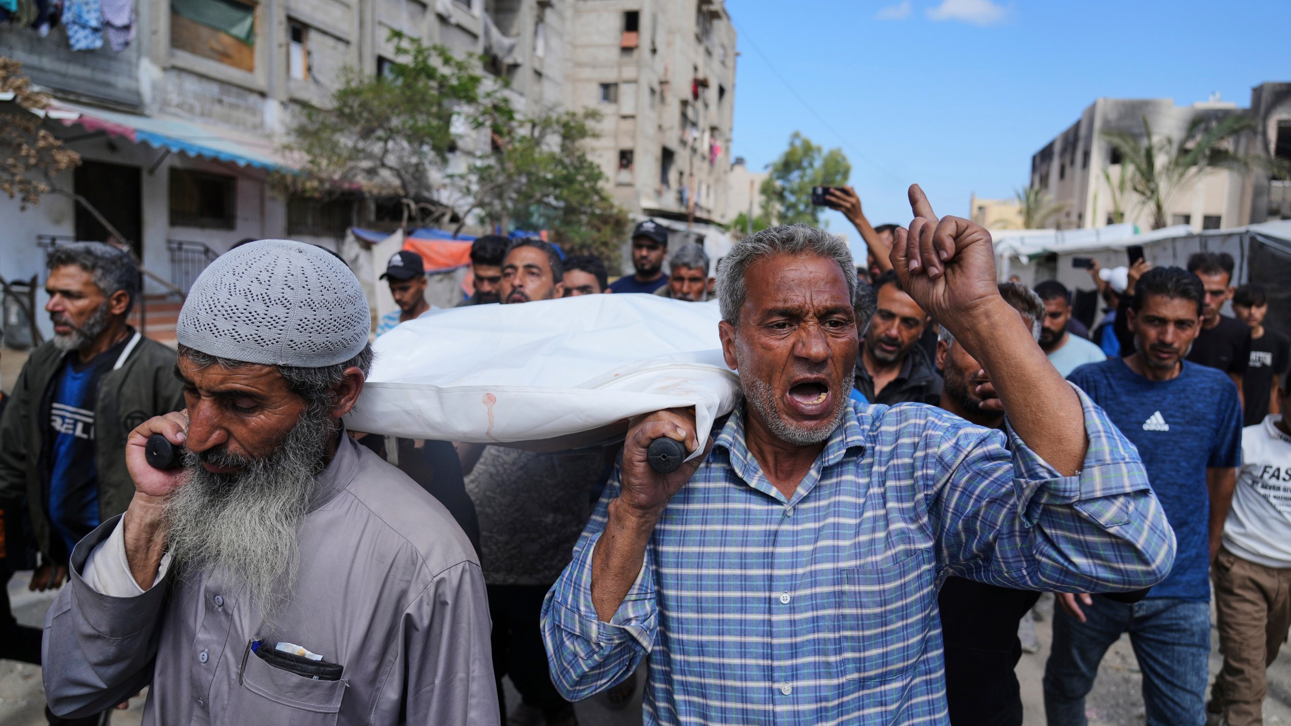 Palestinians carry Reem Al-Akhras, who was killed while heading to an aid distribution hub, during her funeral in Khan Younis, Gaza Strip, Tuesday, June 3, 2025. (AP Photo/Abdel Kareem Hana)