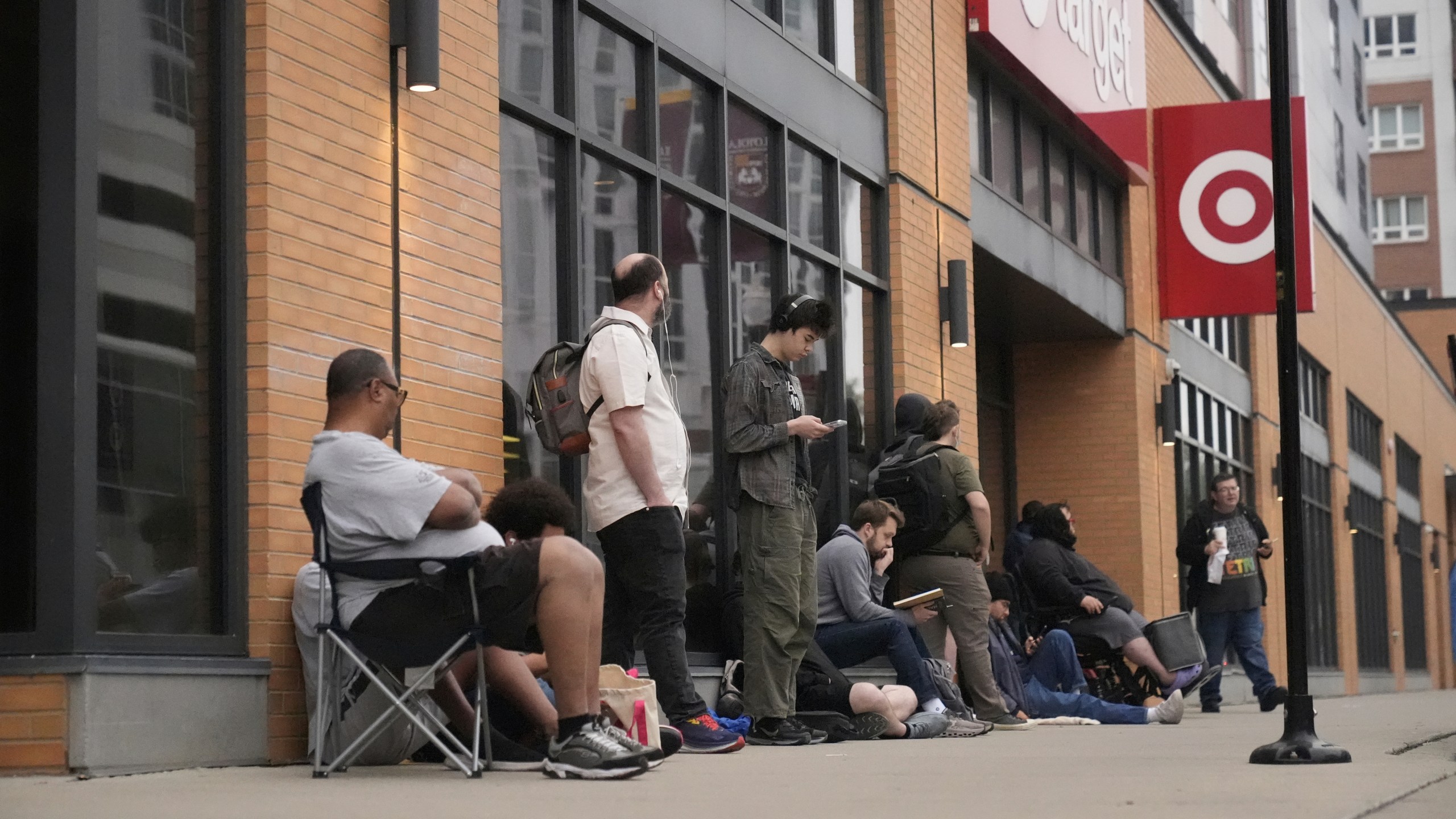 People line up outside a Target store for the new Nintendo Switch 2 video game consoles on Thursday, June 5, 2025 in Chicago. (AP Photo/Kiichiro Sato)