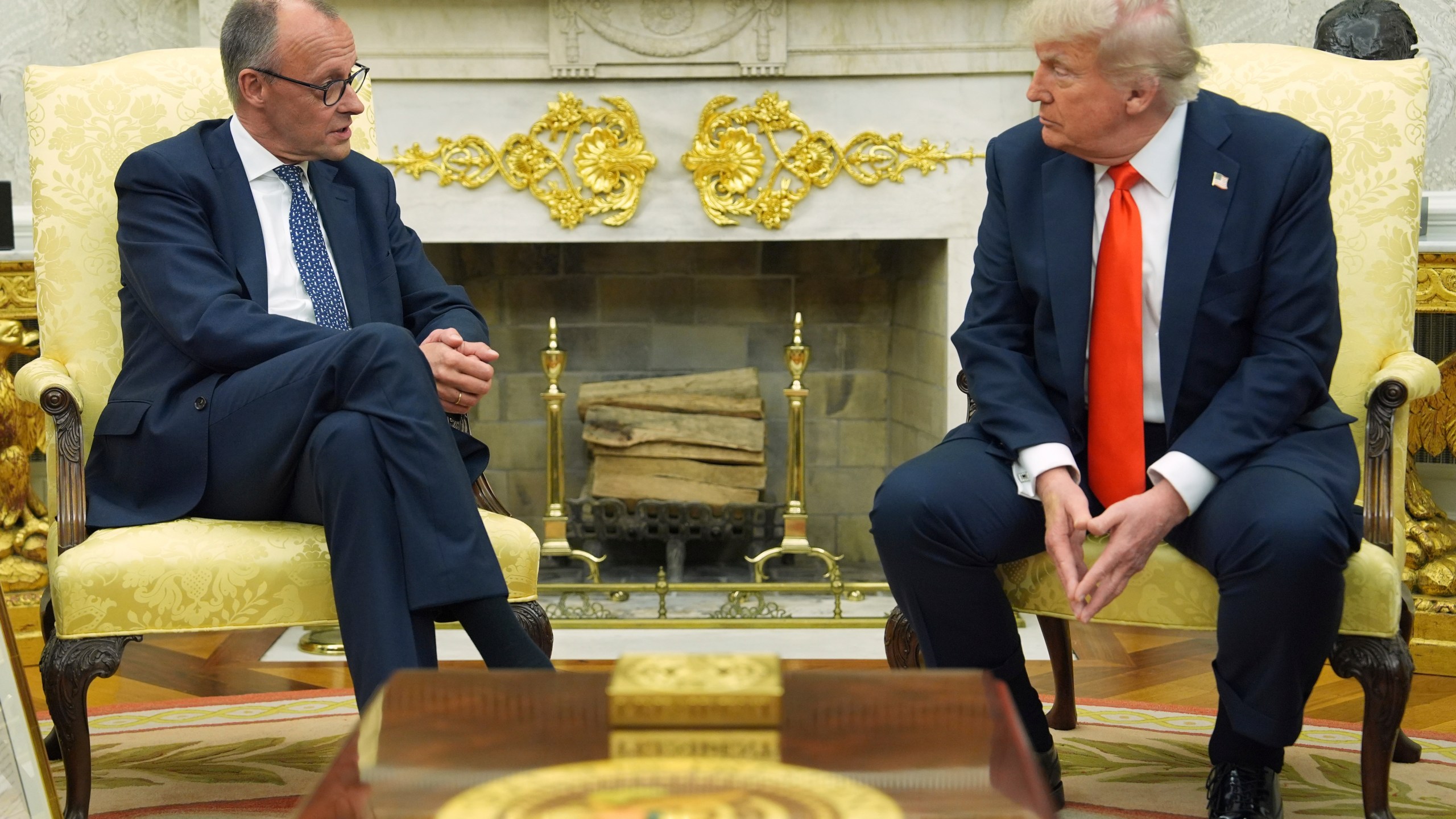 President Donald Trump, right, listens during a meeting with Germany's Chancellor Friedrich Merz in the Oval Office of the White House, Thursday, June 5, 2025, in Washington. (AP Photo/Evan Vucci)