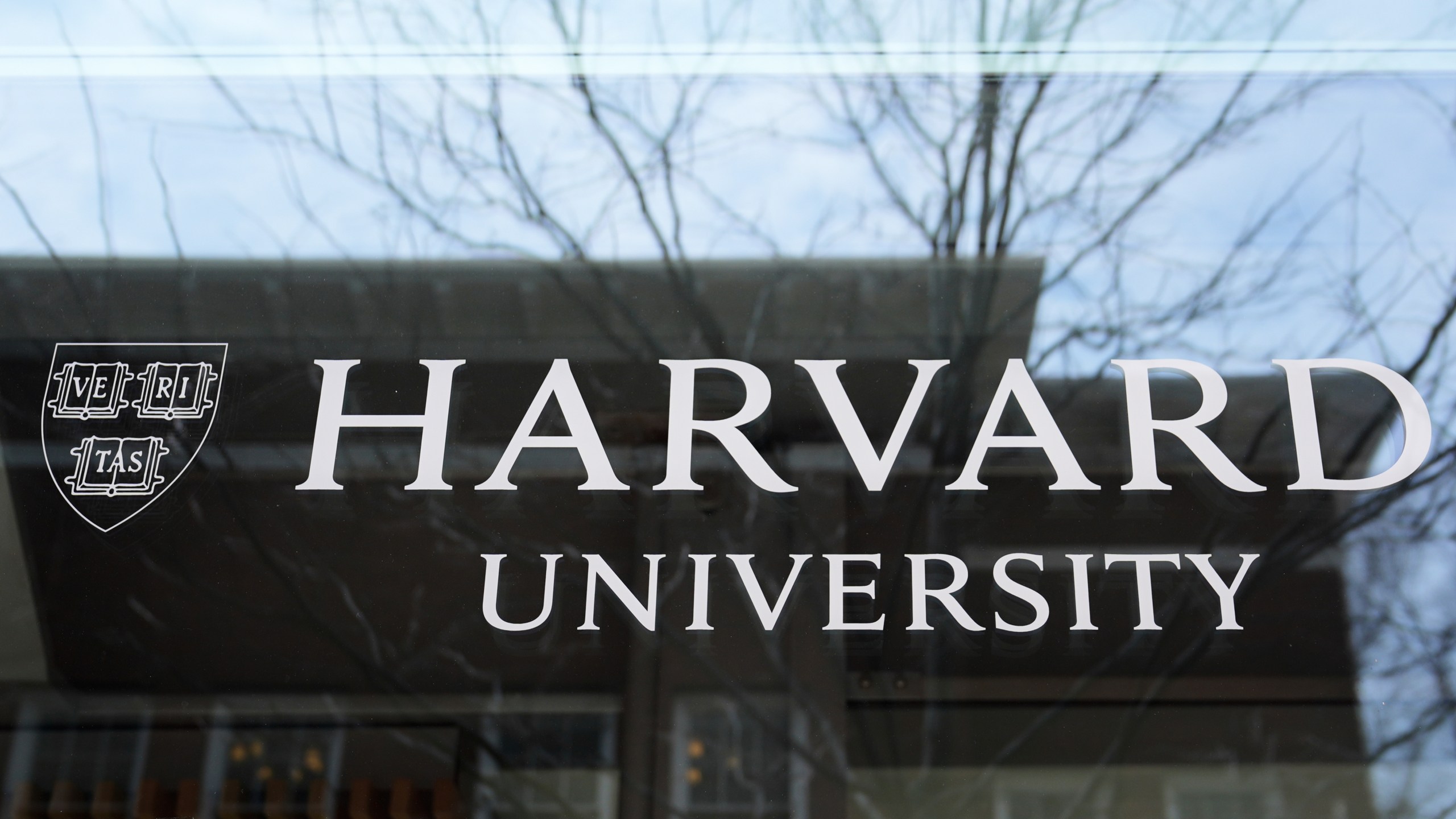 FILE - The Harvard University logo is displayed on a building at the school, Tuesday, April 15, 2025, in Cambridge, Mass. (AP Photo/Charles Krupa, File)