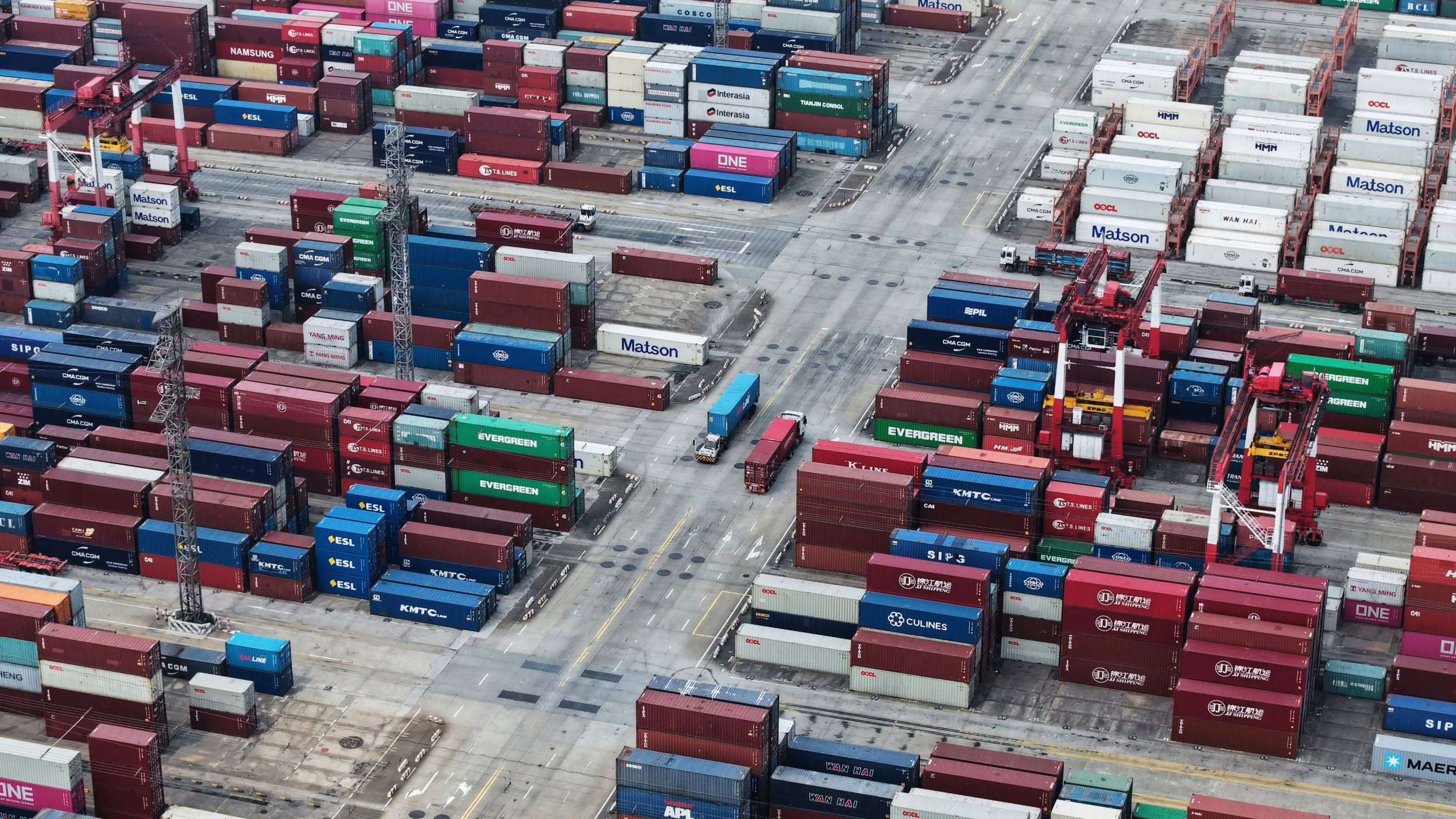 Trucks loaded with container move through a container terminal port in Shanghai, China Monday, June 9, 2025. (Chinatopix Via AP)
