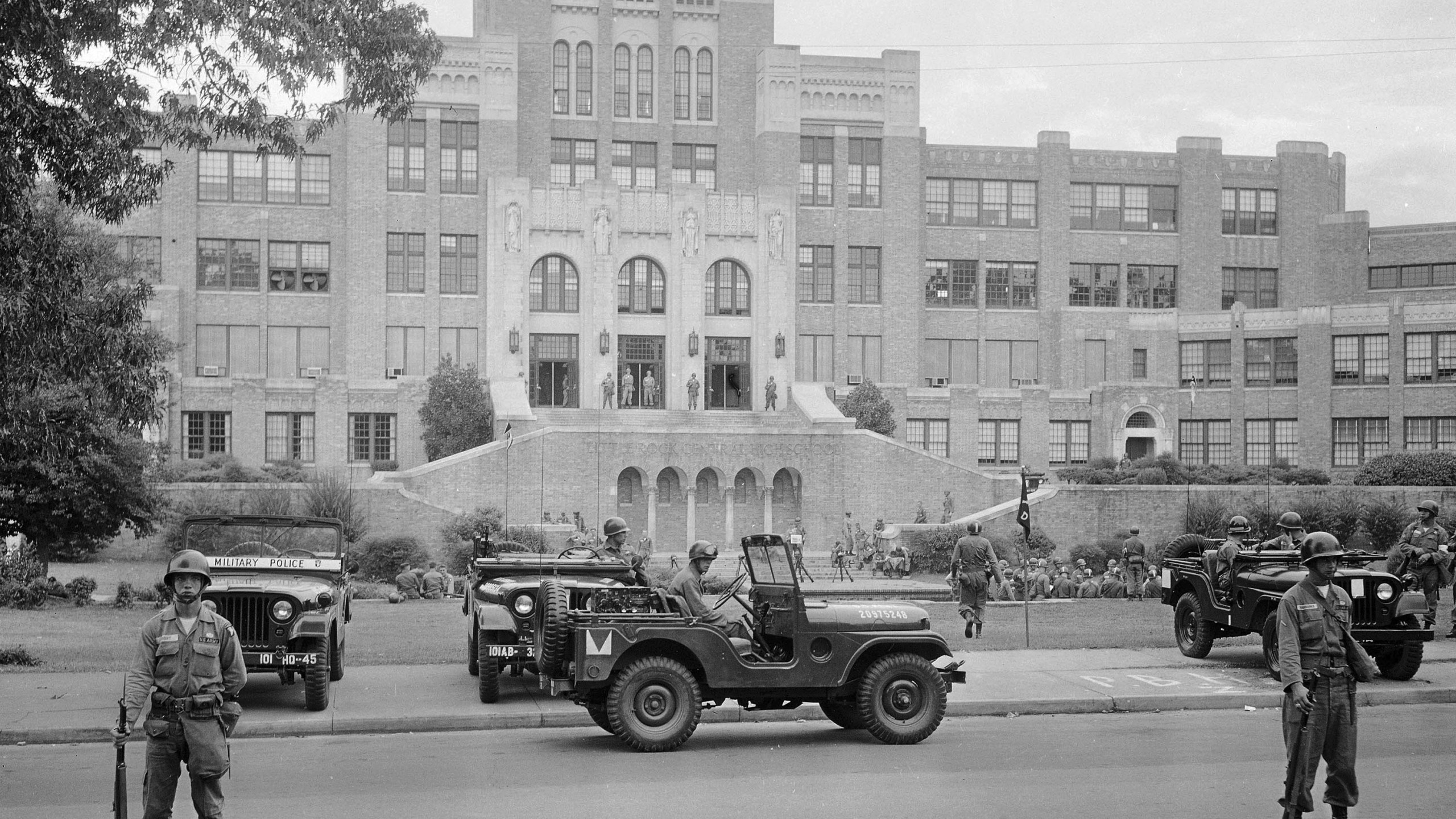 FILE - In this Sept. 26, 1957, file photo, members of the 101st Airborne Division take up positions outside Central High School in Little Rock, Ark. The troops were on duty to enforce integration at the school. (AP Photo/File)