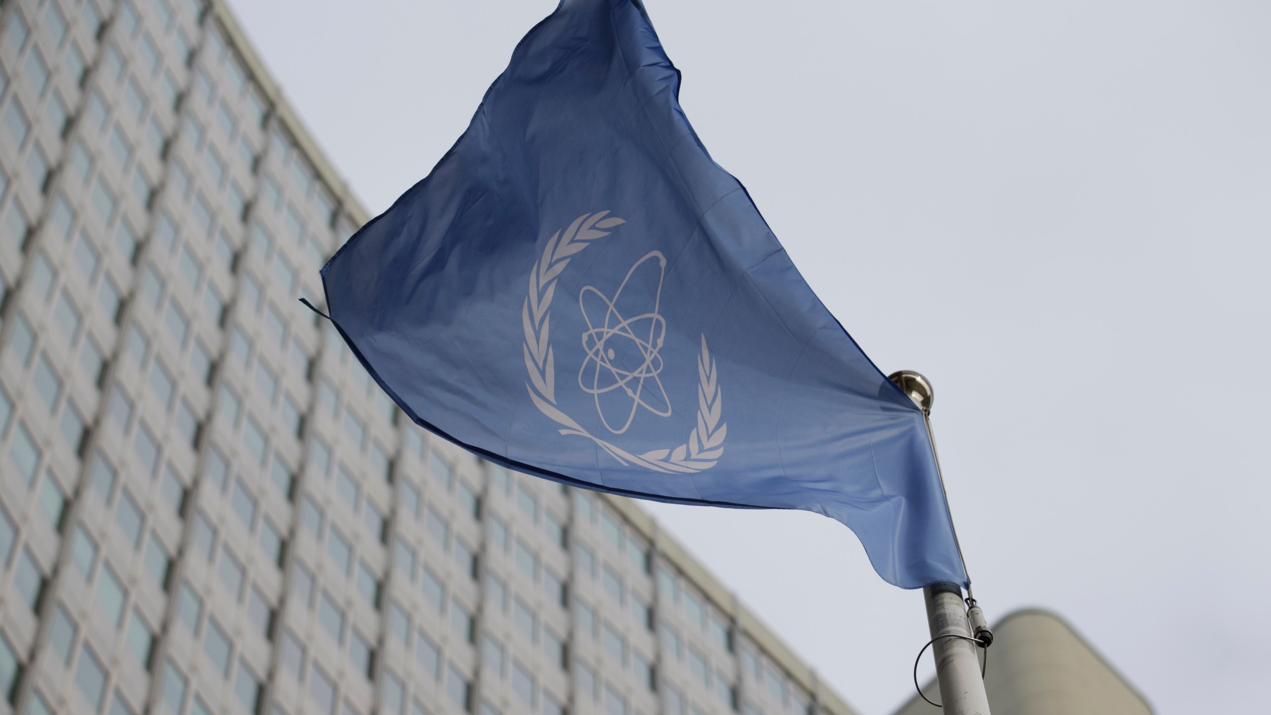 FILE - The flag of the International Atomic Energy Agency flys in front of its headquarters during an IAEA Board of Governors meeting in Vienna, Austria, Feb. 6, 2023. (AP Photo/Heinz-Peter Bader, File)