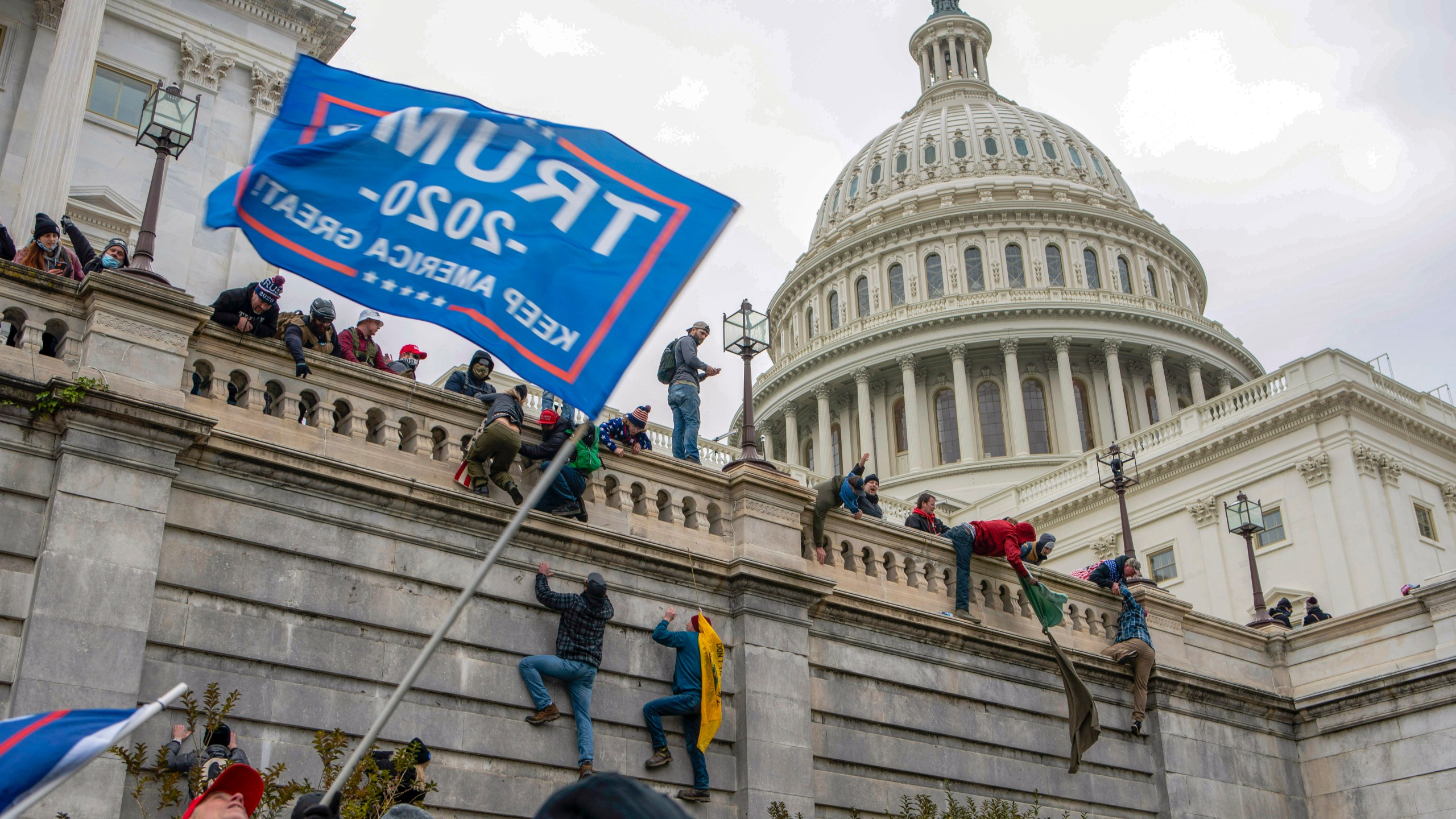FILE - Support of President Donald Trump climb the West Wall of the the U.S. Capitol on Jan. 6, 2021, in Washington. (AP Photo/Jose Luis Magana, file)