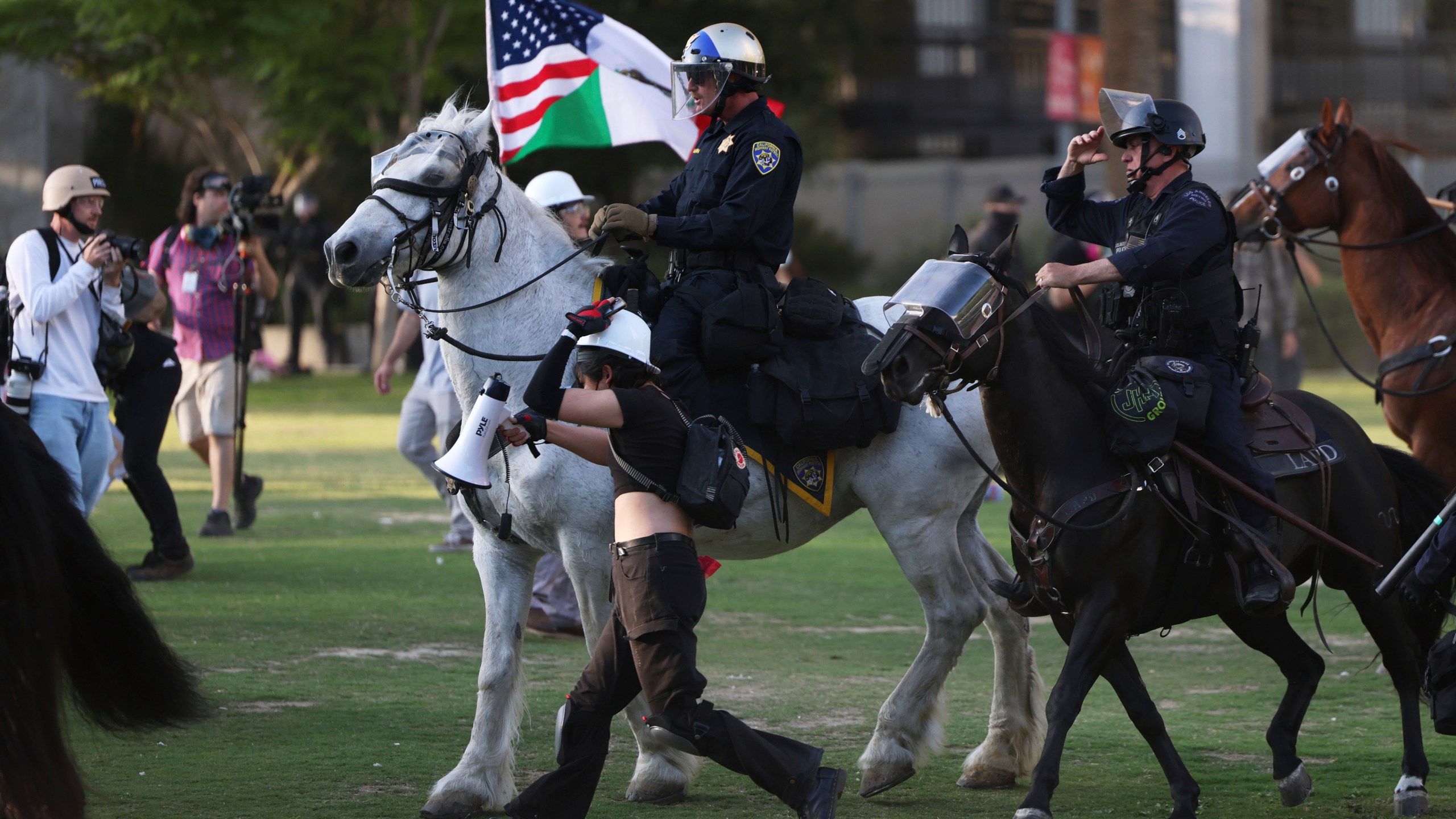 Los Angeles Metro police on horseback disperse protesters on Wednesday, June 11, 2025, in Los Angeles. (AP Photo/Ethan Swope)