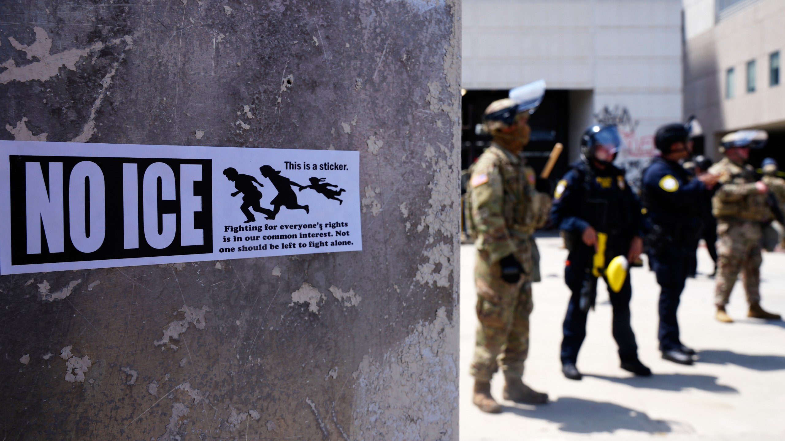 DHS police and National Guard troops outside the Metropolitan Detention Center