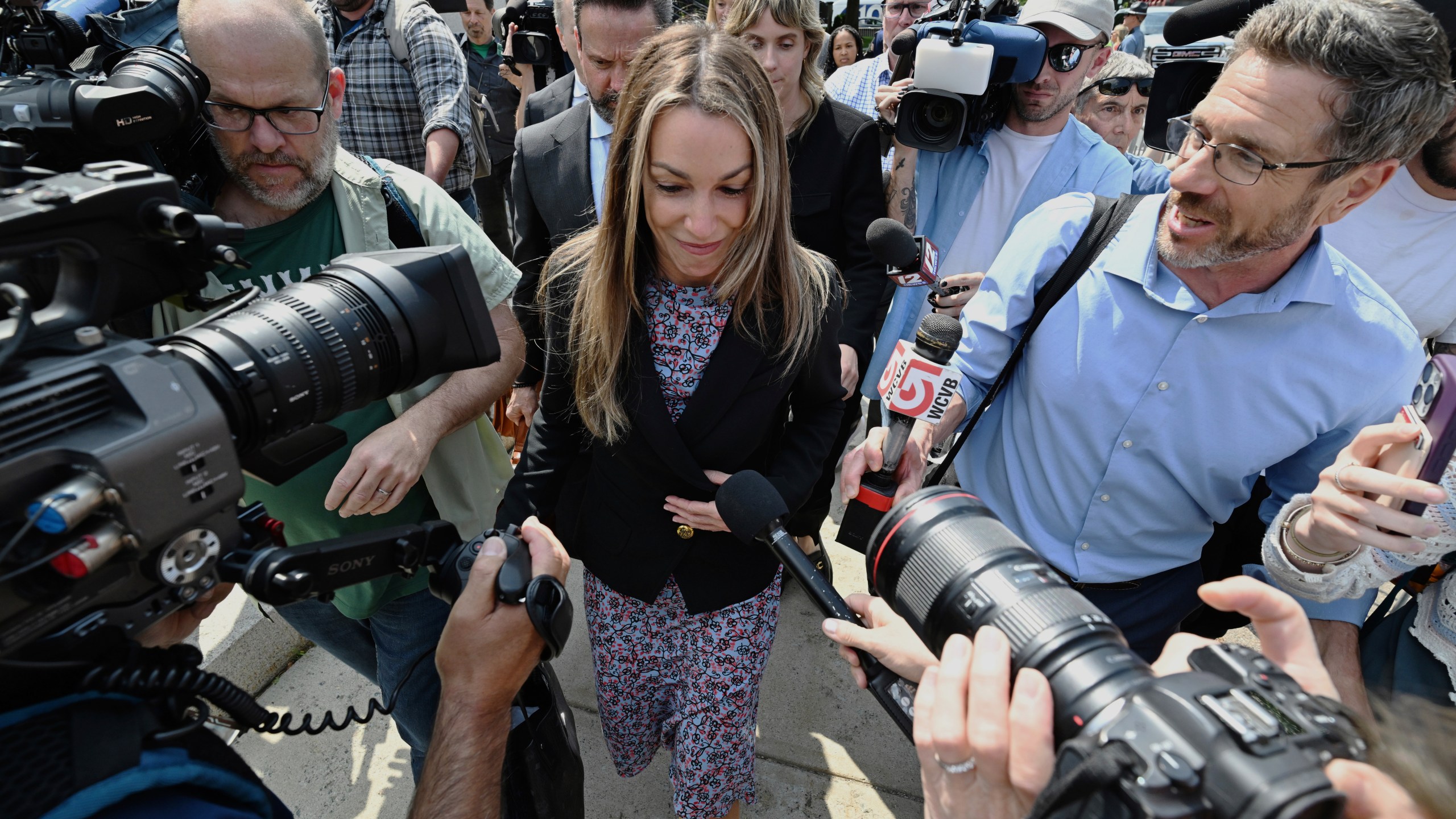Karen Read surrounded by reporters as she leaves the courthouse