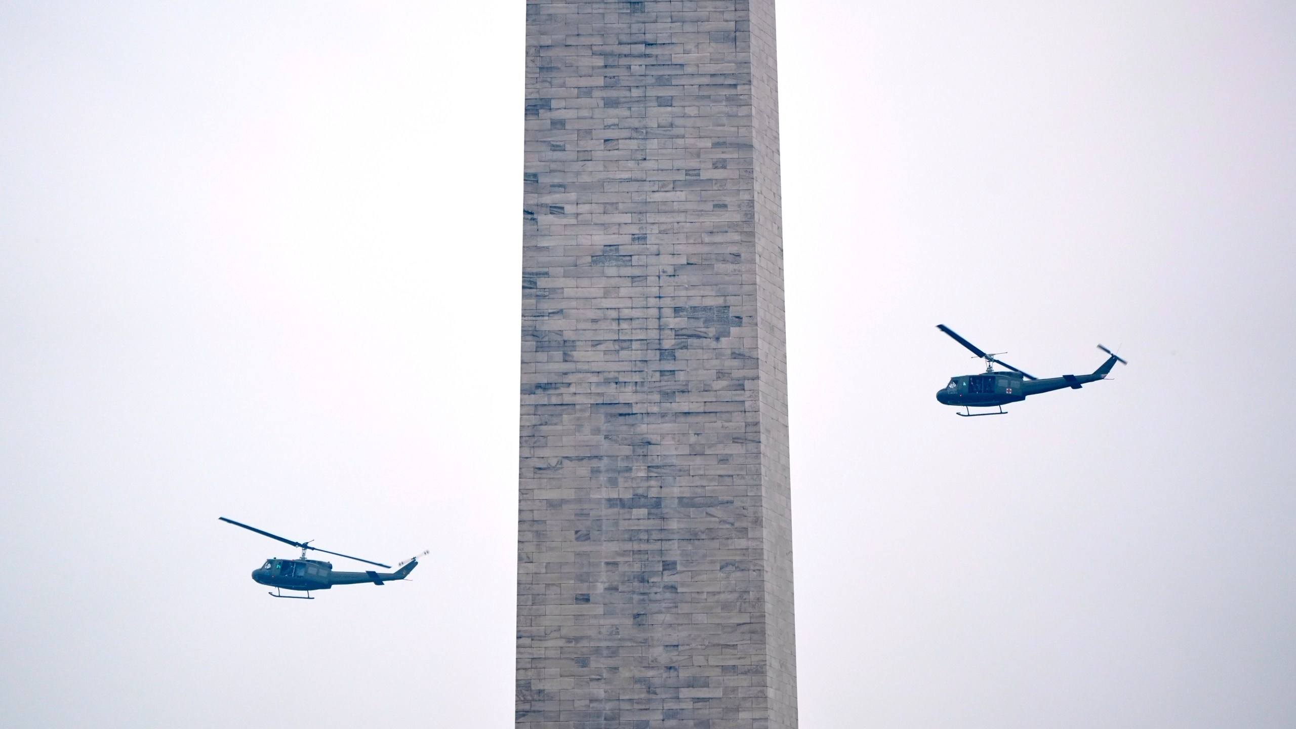 U.S. Army UH-60M Black Hawk helicopters perform a flyover during an event to honor the Army's 250th anniversary, coinciding with President Donald Trump's 79th birthday, Saturday, June 14, 2025, in Washington. (AP Photo/Mark Schiefelbein)