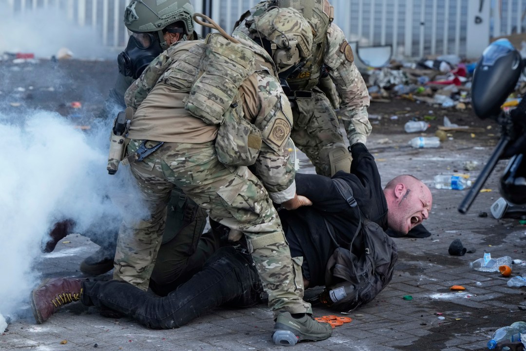 U.S. Customs and Border Protection agents detain a man outside the U.S. Immigration and Customs building during a protest Saturday, June 14, 2025, in Portland, Ore. (AP Photo/Jenny Kane)