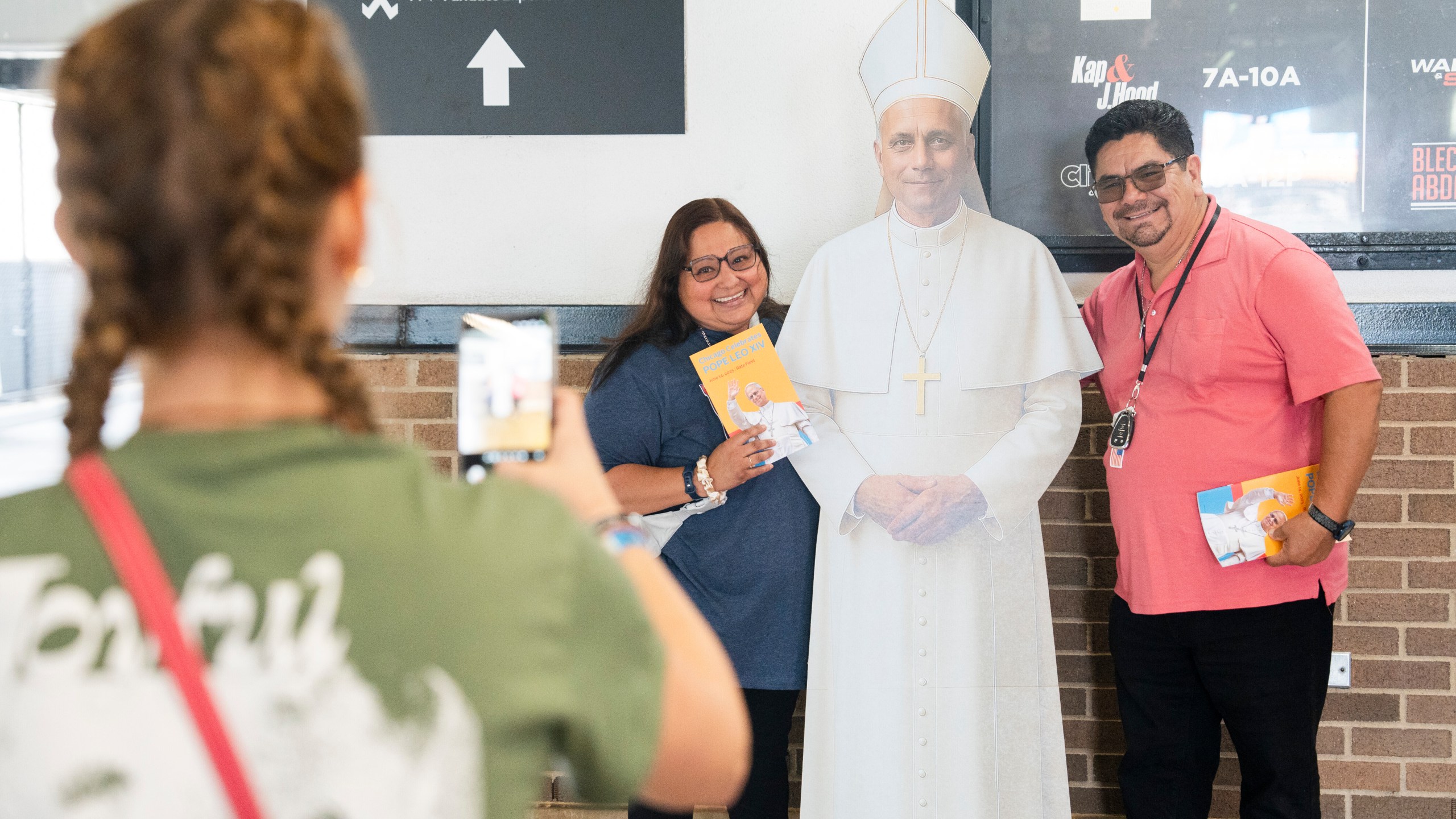 Maria Marin and her husband, Martin Marin, pose with a cardboard cutout of Pope Leo XIV during the Archdiocese of Chicago's celebration of Pope Leo XIV at Rate Field, Saturday, June 14, 2025. (Pat Nabong/Chicago Sun-Times via AP)