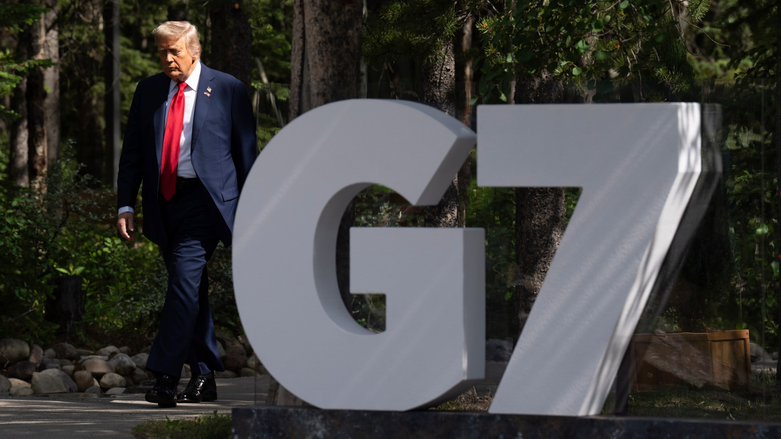 United States President Donald Trump makes his way to the official welcome at the G7 Summit in Kananaskis, Alberta, Canada, Monday, June 16, 2025. (Adrian Wyld/The Canadian Press via AP)