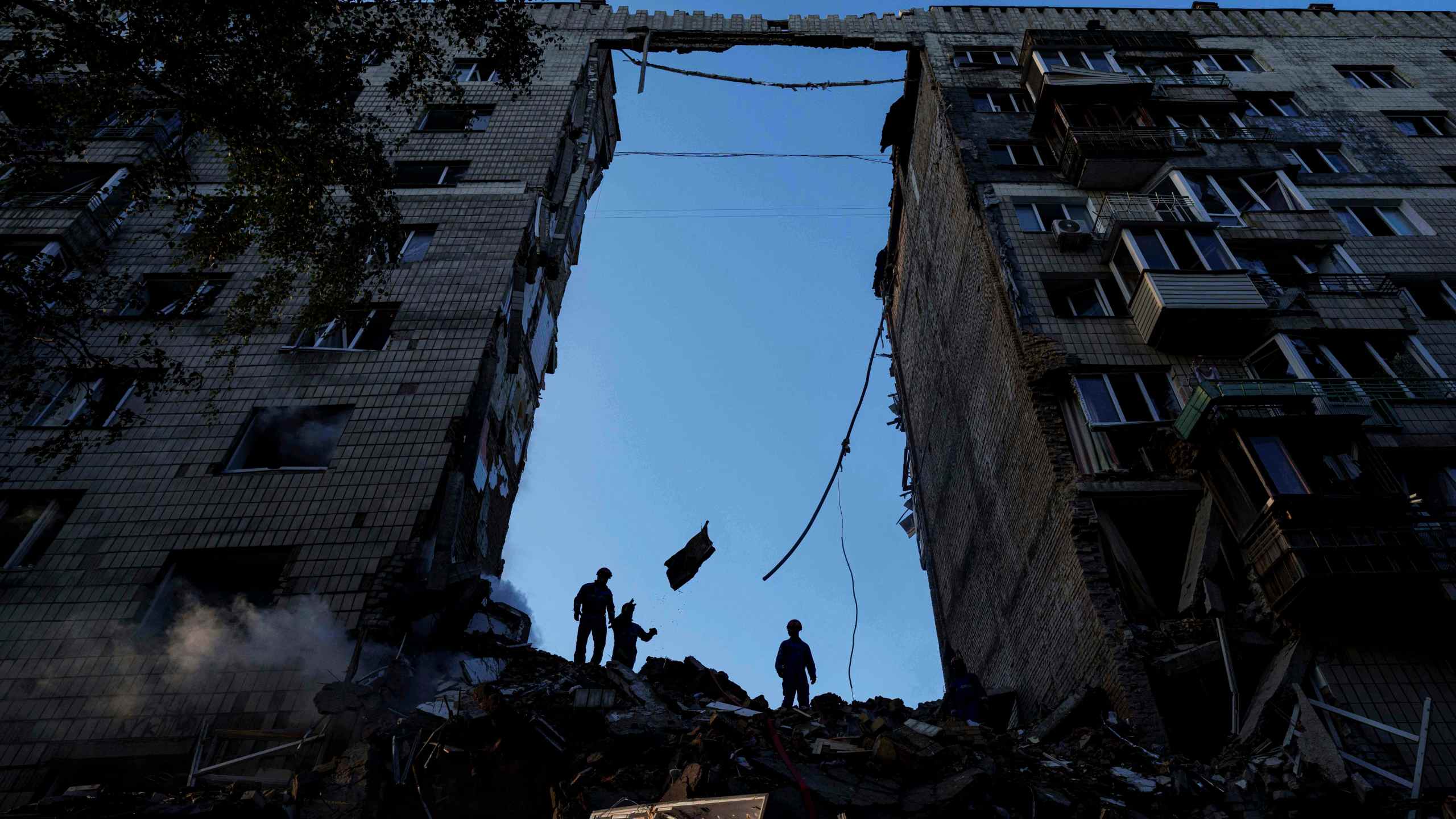 Rescue workers clear the rubble of a residential house