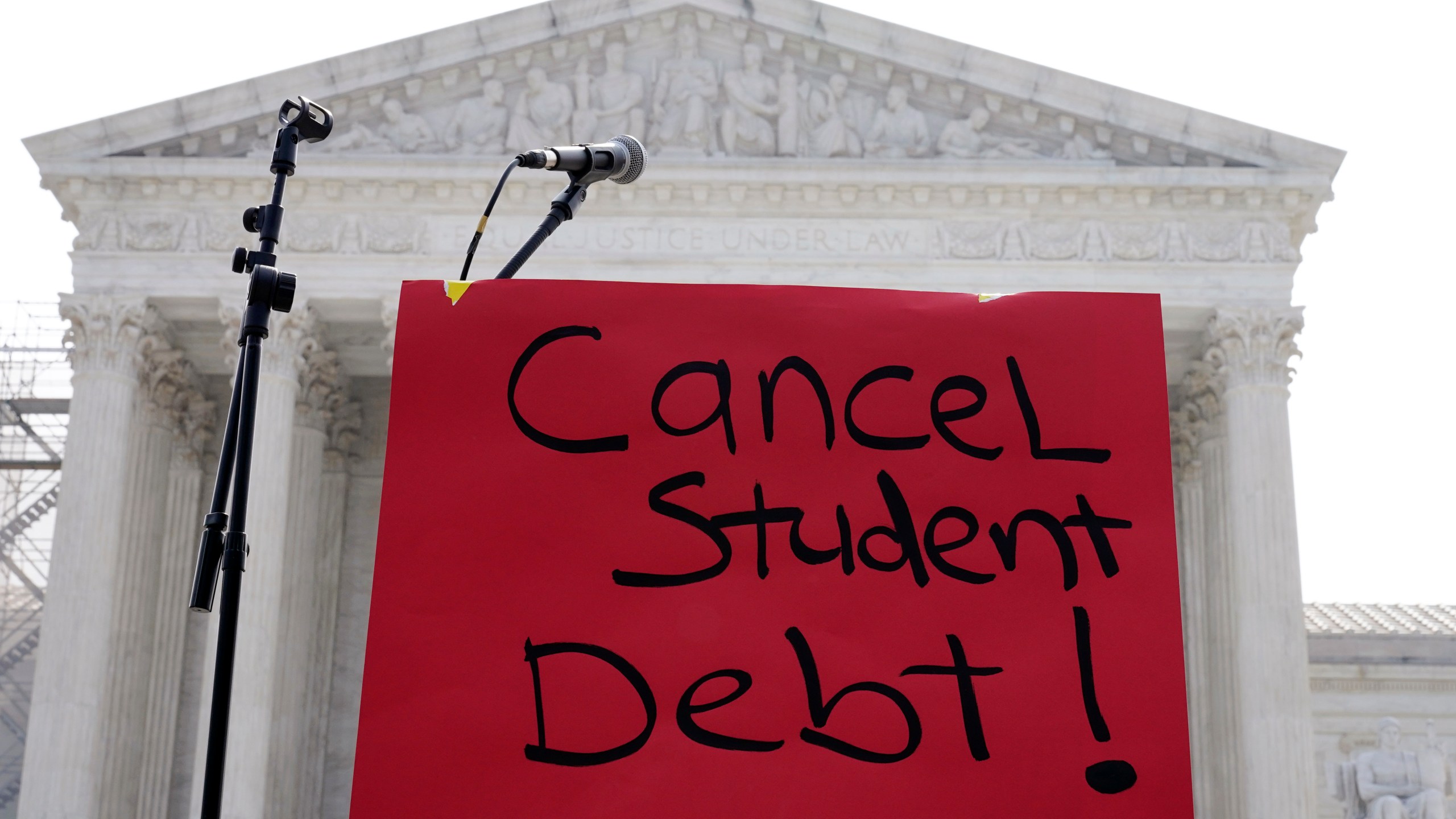 FILE - A sign reading "cancel student debt" is seen outside the Supreme Court, June 30, 2023, in Washington. (AP Photo/Mariam Zuhaib, File)