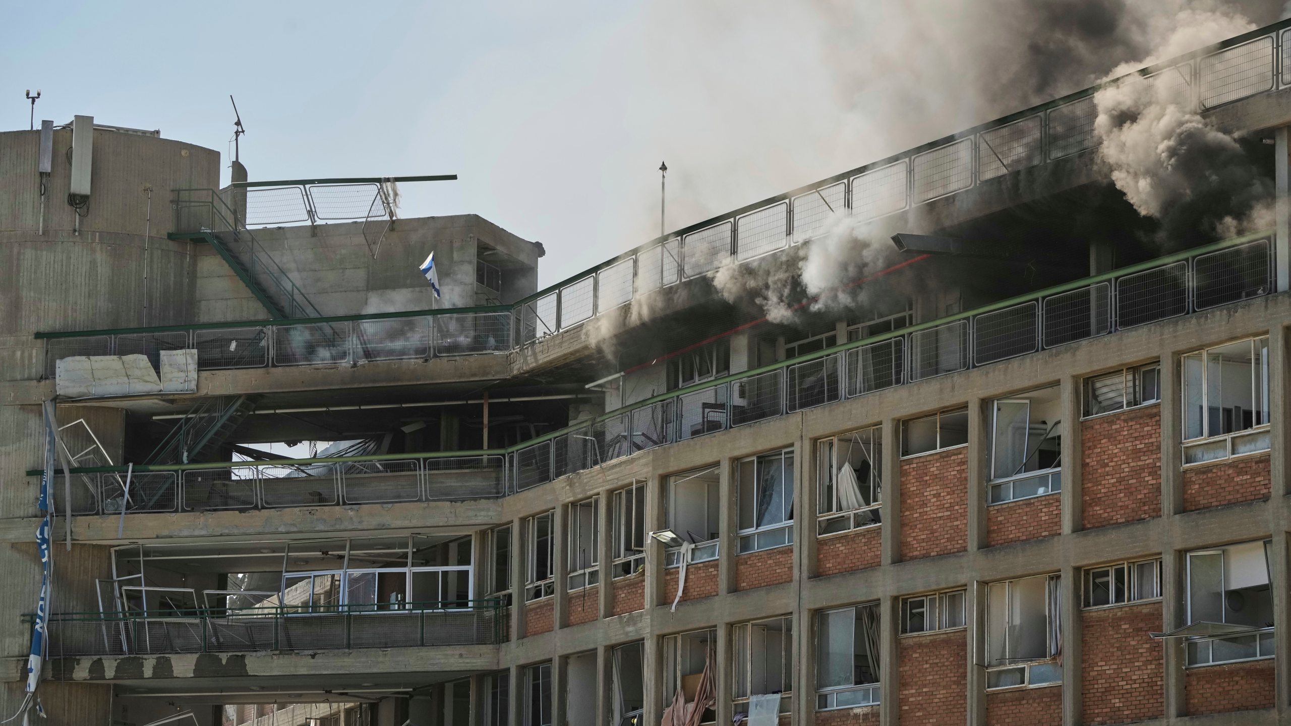 Smokes rises from a building of the Soroka hospital complex after it was hit by a missile fired from Iran in Beersheba, Israel, Thursday, June 19, 2025. (AP Photo/Leo Correa)