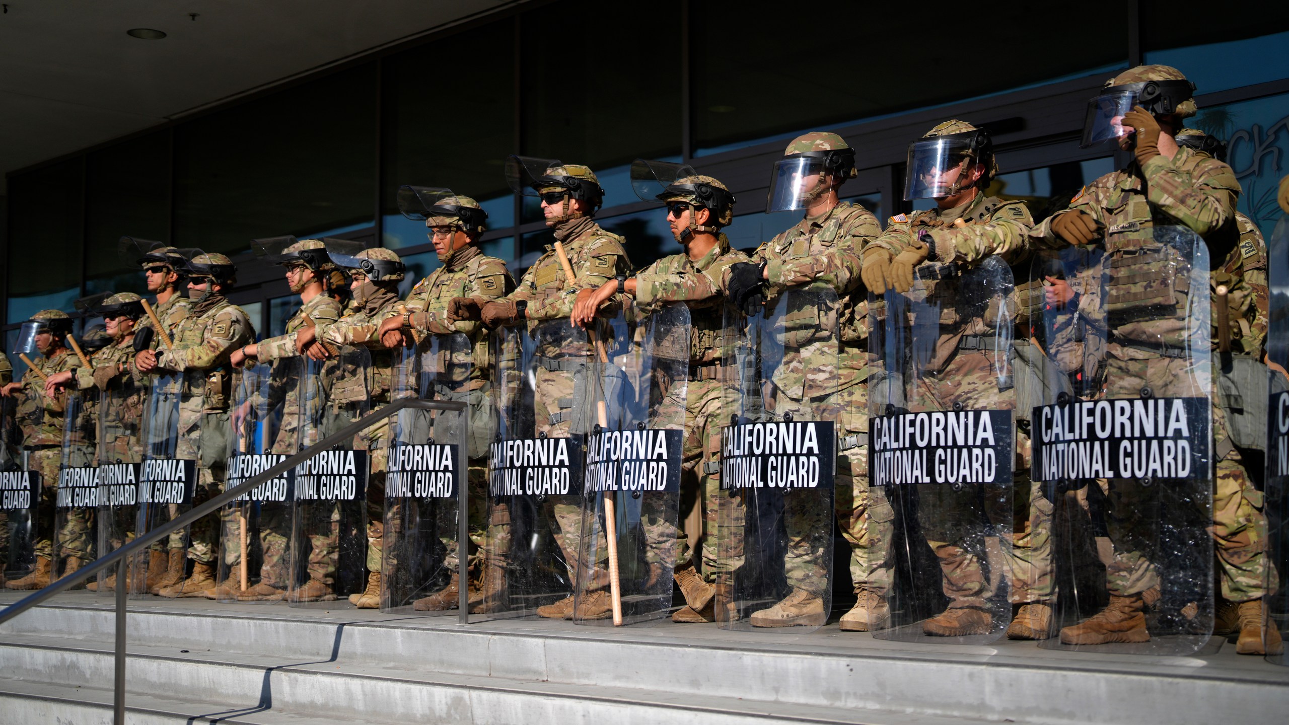 California National Guard troops stand in formation outside a building