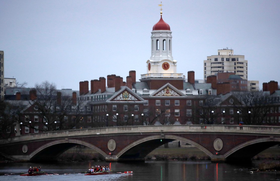 FILE - Rowers paddle down the Charles River near the campus of Harvard University in Cambridge, Mass., March 7, 2017. (AP Photo/Charles Krupa, File)