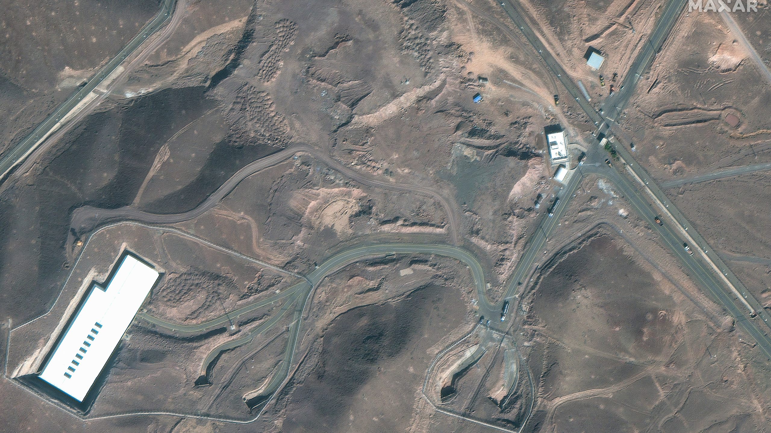 This satellite image provided by Maxar Technologies shows vehicles at the Fordo enrichment facility in Iran on Friday, June 20, 2025. (Maxar Technologies via AP)