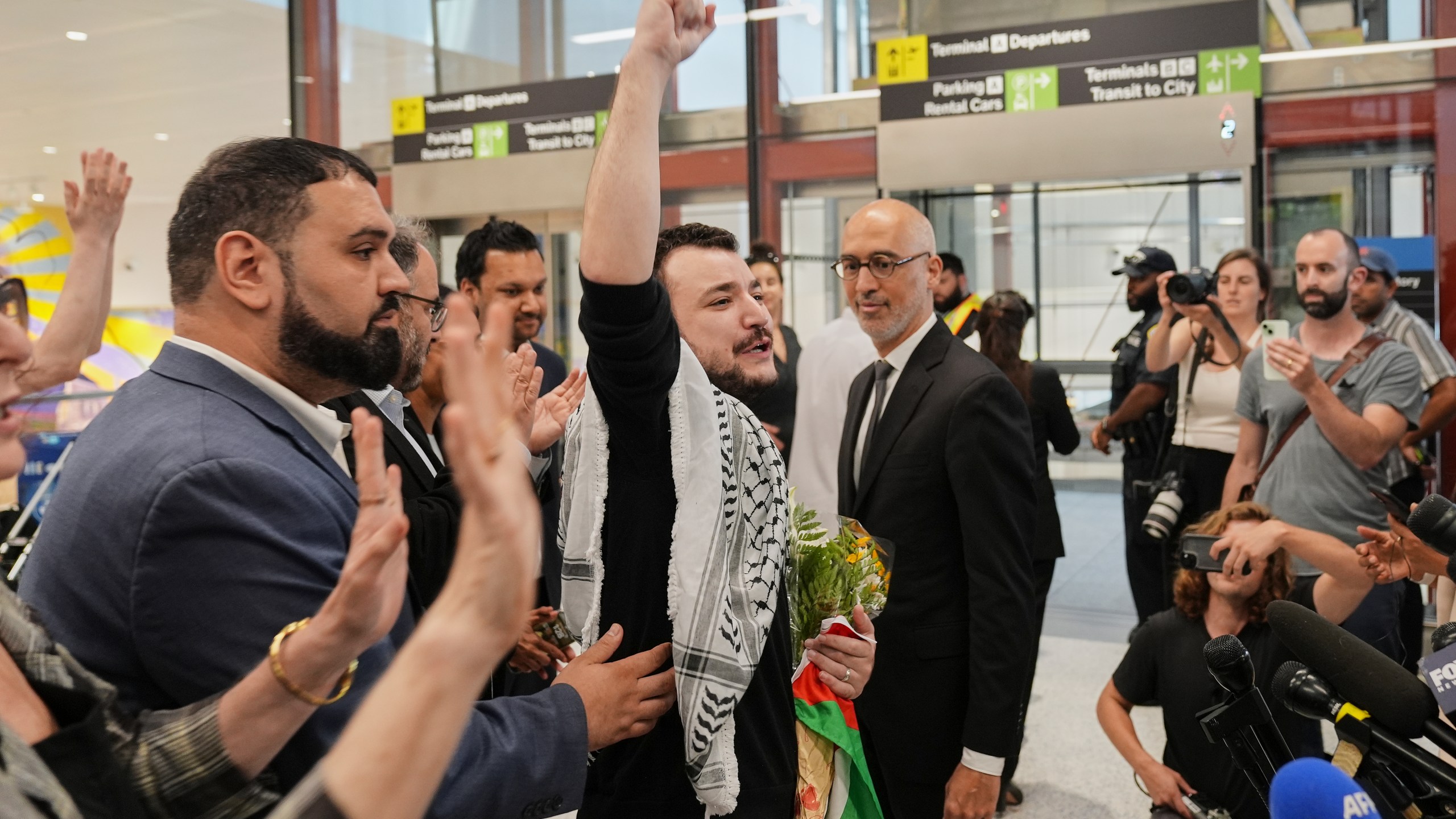 Mahmoud Khalil, center, reacts as he is greeted upon arriving at Newark International Airport, Saturday, June 21, 2025, in Newark, N.J. (AP Photo/Seth Wenig)