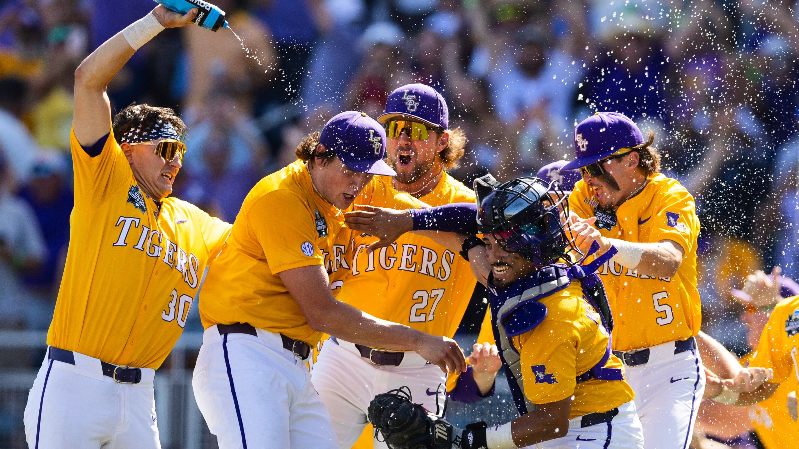 LSU players celebrate their 5-3 win over Coastal Carolina in Game 2 of the NCAA College World Series baseball finals in Omaha, Neb., Sunday, June 22, 2025. (AP Photo/Rebecca S. Gratz)
