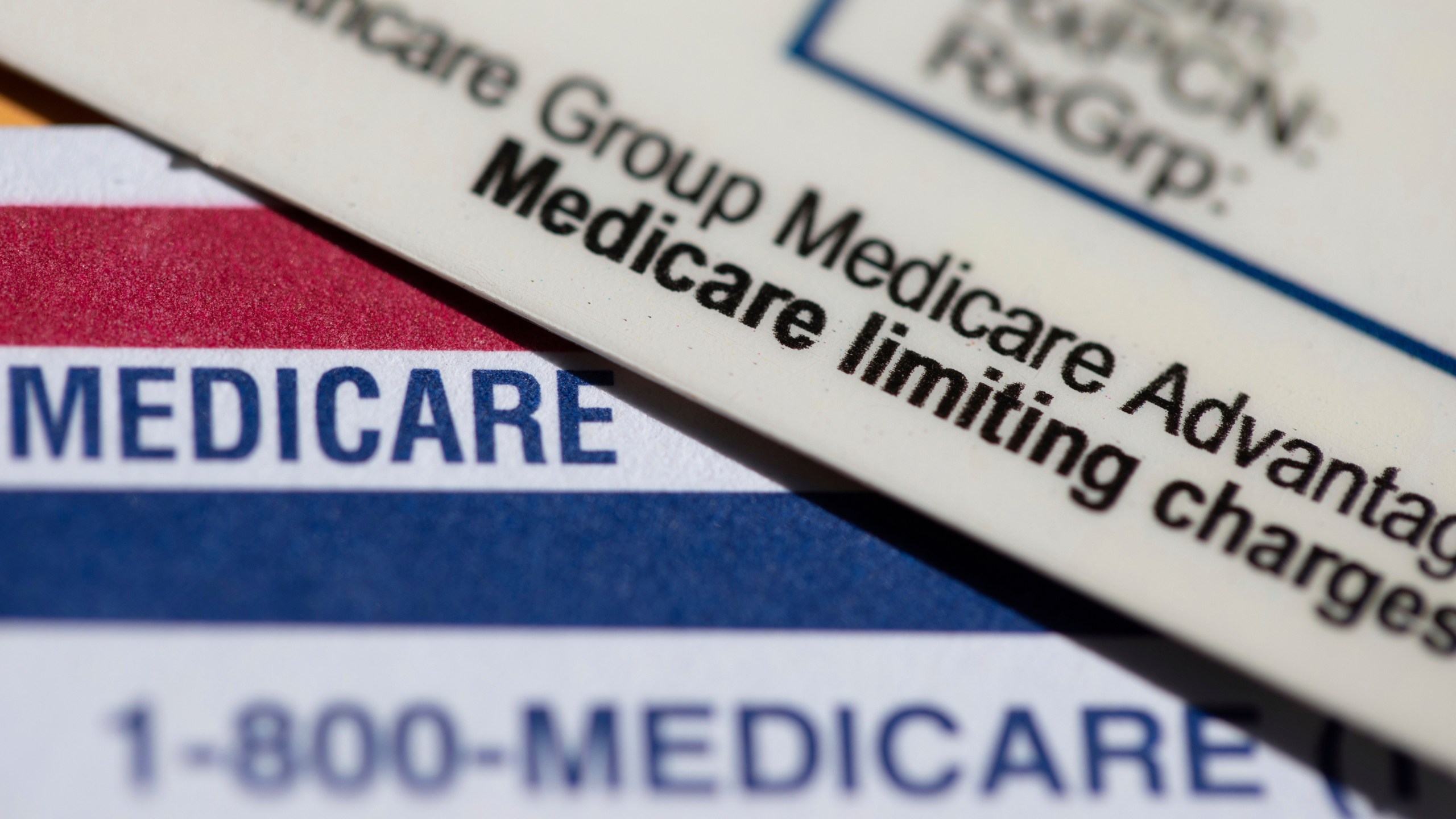 A Medicare Advantage PPO card sits on top of a Medicare card